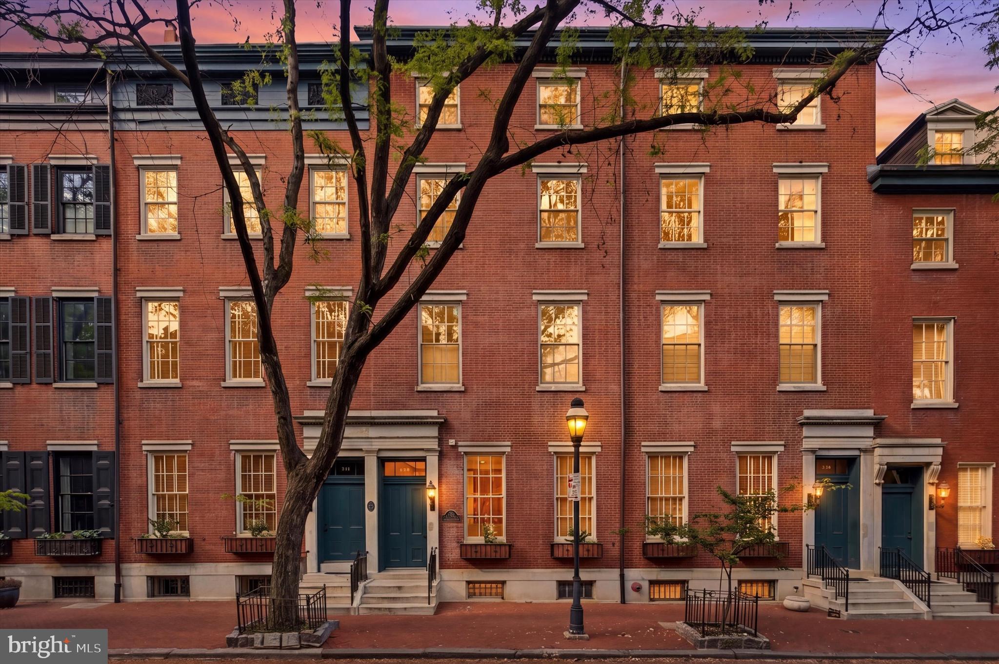 Nestled within the Coles House Condominium on picturesque, tree-lined Clinton Street, often affectionately referred to as “Midtown’s Delancey” for its timeless beauty, historic charm, and unmistakable sense of place, this exceptional 3-bedroom, 3.5-bath residence with parking offers the grandeur and architectural presence of a classic townhome, paired seamlessly with the ease and convenience of condominium living.
Framed by a stately red brick façade and elegant white marble steps, the building makes a memorable first impression. Inside, a well-appointed lobby with controlled entry sets the tone, while a rear entrance provides effortless access just steps from your deeded parking space. An elevator delivers you directly to the second floor, where Unit 203 begins to unfold.
A welcoming foyer with coat closet opens into a breathtaking living and dining space defined by soaring ceilings, rich hardwood floors, and a gas fireplace that anchors the room with warmth and character. Expansive south-facing windows flood the home with natural light, and with nearly all windows recently replaced, including six restored historic façade windows, the home now offers both enhanced efficiency and preserved architectural integrity. Fresh paint throughout provides a crisp, clean, move-in-ready canvas.
The open dining area sits at the heart of the home, perfectly scaled for lively dinner parties or intimate evenings alike. Just beyond, the thoughtfully designed chef’s kitchen features stainless steel appliances, custom wood cabinetry, generous storage, and a wraparound island that naturally becomes the gathering place, whether for morning coffee, a glass of wine, or conversation that lingers long after the meal is over. A conveniently located powder room completes this level.
A graceful staircase leads to two spacious secondary bedrooms, each with its own full bath and ample closet space, one currently styled as a flexible office or den. A dedicated laundry room with additional storage sits just off the hallway, adding everyday practicality to the home’s elegant design.
The entire third floor is reserved for a truly special retreat: a stunning primary suite that feels like its own private sanctuary. Here, a generously sized bedroom with soaring ceilings overlooks acclaimed Clinton Street and is complemented by abundant closet space and a luxurious bath featuring a walk-in shower, soaking tub, and large marble double vanity. An additional staircase leads to attic storage, an uncommon and highly valuable bonus in city living.
Back on the main level of the building, residents enjoy a mail and package room, bicycle storage, basement storage, and easy rear access to parking. The association is known for its attentive stewardship and proactive maintenance, providing confidence in both the building’s care and its long-term value.
All of this, set on one of the city’s most enchanting blocks, where mature trees canopy the street, historic façades create a storybook backdrop, and the rhythm of neighborhood life feels both peaceful and connected. With a Walk Score of nearly 100, the very best of Center City living is just moments away.
A spectacular home. A storied street. And a setting that feels nothing short of magical.