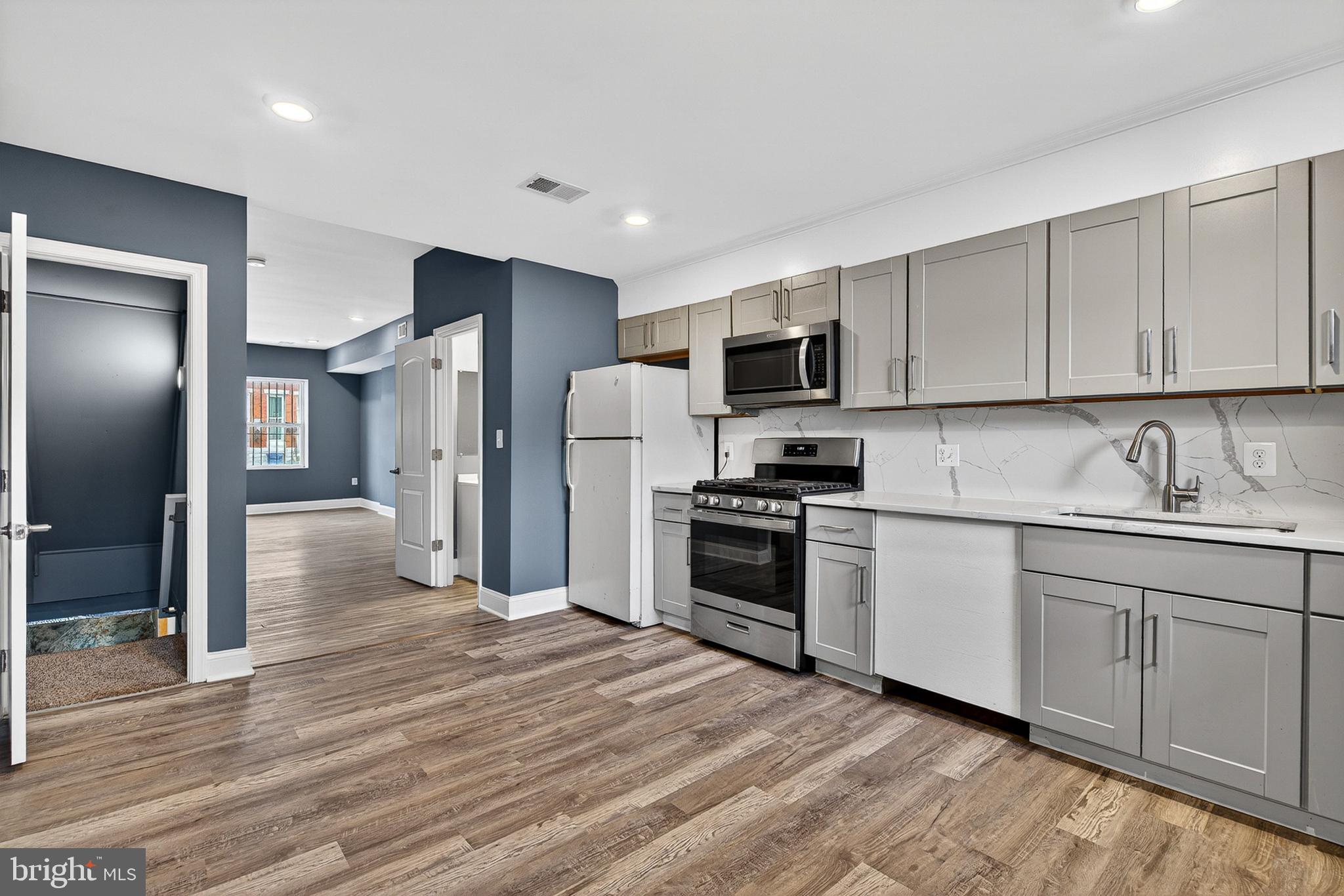 Attention Investors & First-Time Home Buyers!
Welcome to this newly updated, move-in-ready townhome located in the heart of Baltimore. Offering a perfect blend of modern upgrades and affordable pricing, this property represents an incredible turnkey opportunity for an savvy investor looking to add a high-yield asset to their portfolio, or a first-time buyer looking for a beautiful, budget-friendly place to call home.
Key Property Features
Main Level Living: Step into a spacious, light-filled living area featuring contemporary slate-blue walls, crisp white trim, recessed lighting, and durable wood-look flooring that flows continuously throughout the open-floor concept.
Updated Kitchen: The bright, eat-in kitchen boasts stylish grey cabinetry, modern countertops with a striking marble-patterned backsplash, a deep stainless steel sink, and a matching stainless steel gas range and microwave setup.
The upper levels offer well-proportioned bedrooms with excellent natural light, fresh paint, matching wood-look floors, and built-in closet storage with wire shelving. The home features updated bathroom spaces, highlighted by a clean main bath equipped with a modern vanity, neutral wood-style floor tile, and a fully tiled walk-in shower with elegant marble-patterned surrounds. The kitchen leads directly out to a fully fenced, low-maintenance rear concrete courtyard—perfect for outdoor grilling, seating, or secure pet placement.
A full, unfinished basement offers massive potential for storage or a workshop, already clean and housing updated mechanical systems, including the furnace and hot water heater.
Why This is the Perfect Investment
For First-Time Buyers: Why rent when you can own? At $140,000, your monthly mortgage payment could be significantly lower than local rent rates. Enjoy the peace of mind that comes with updated flooring, fresh paint, functional systems, and modern kitchen updates without the hefty price tag.
For Landlords & Investors: This property is a rental powerhouse. Its turnkey condition means zero downtime or immediate renovation costs—just close, market, and immediately start collecting strong cash flow in a high-demand rental market.
Don't miss out on this fantastic Baltimore value. Schedule your private tour today before it's gone!