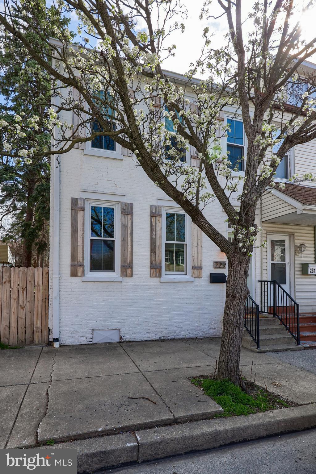 Nestled in the heart of Columbia, Pennsylvania, this beautifully remodeled end-of-row townhome seamlessly blends historic charm with modern comfort. Its prime location offers easy access to local restaurants, parks, shopping, and major highways, making it perfect for both convenience and leisure.

Step inside to discover a thoughtfully updated interior featuring a spacious living room with refinished hardwood floors and striking exposed brick accent walls that add warmth and character. The stylish kitchen boasts granite countertops, stainless steel appliances, and sleek cabinetry, creating an ideal space for cooking and entertaining. A large dining room and a convenient half bath complete the main level.

The second floor hosts two well-appointed bedrooms, including a spacious primary suite complete with a walk-in closet and a luxurious updated bathroom featuring a tiled shower and double vanity. The second bedroom offers a private balcony, perfect for enjoying fresh air and natural light. A second full bathroom on this level has been elegantly updated with a tiled tub-shower combo and a modern vanity.

An additional third-floor bedroom provides flexible space for guests, a home office, or a cozy retreat. Modern conveniences like natural gas heat and central air ensure year-round comfort.

Outside, the fenced backyard and covered deck offer a private oasis for relaxation or outdoor gatherings. The property also includes space for off-street parking at the rear.