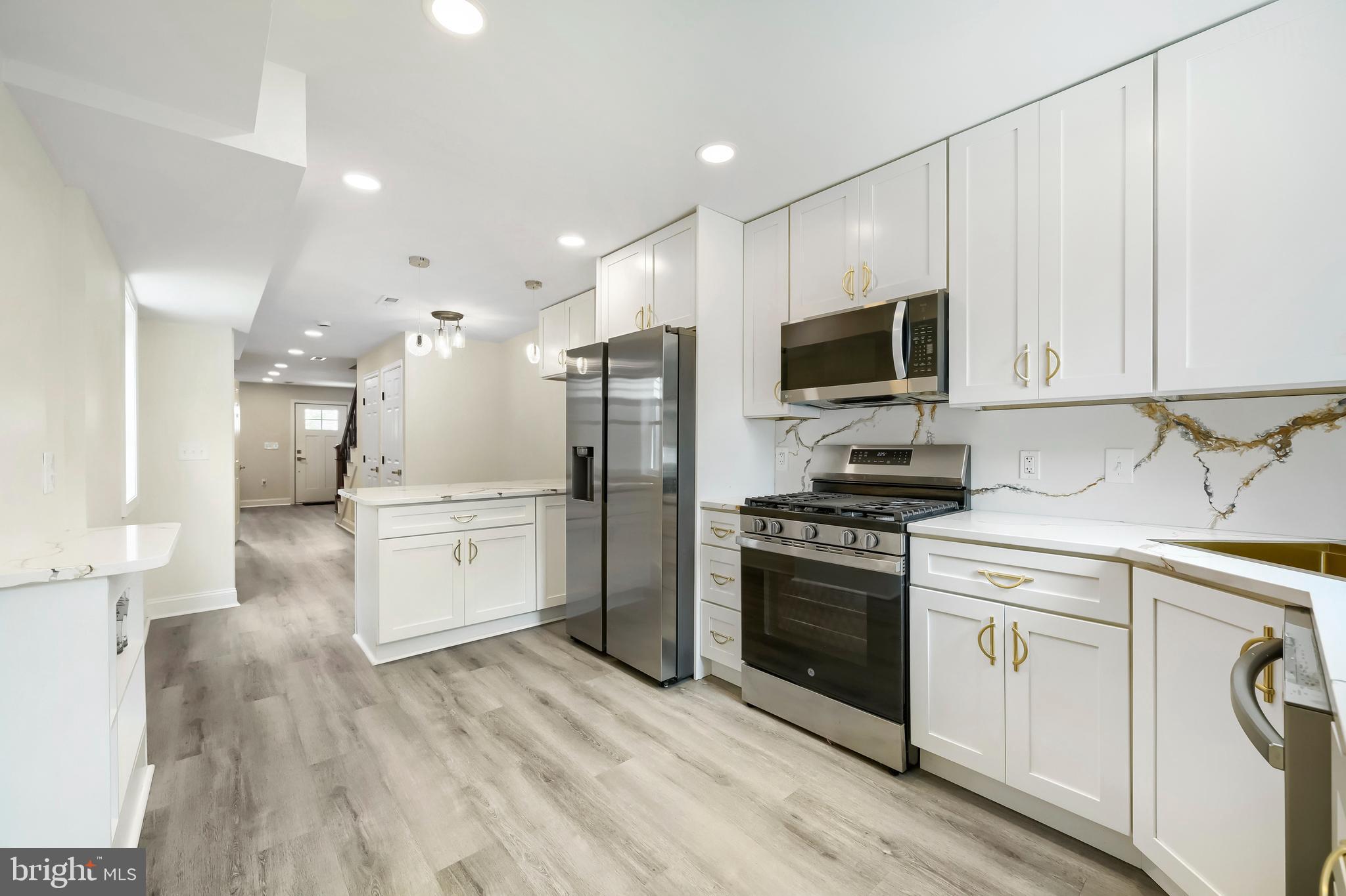 Welcome to this beautifully renovated rowhome in Baltimore's Mint Hill neighborhood, where modern style meets everyday comfort. Thoughtfully redesigned from top to bottom, this move-in-ready home offers quality craftsmanship and stylish finishes that set it apart from the typical renovation. 
Step inside to a bright, open-concept main level designed for both everyday living and entertaining. The stunning kitchen serves as the heart of the home, featuring elegant quartz countertops, stainless steel appliances, custom cabinetry, brushed gold fixtures, designer lighting, and a convenient breakfast bar perfect for casual dining or gathering with guests.

Upstairs, you'll find beautifully updated living spaces and spa-inspired bathrooms showcasing modern ceramic tile, brushed gold accents, and timeless finishes that create a clean, sophisticated feel throughout.
Outside, enjoy a fully fenced rear yard with a private patio and green space—ideal for summer cookouts, entertaining friends, gardening, or simply relaxing after a long day.

Conveniently located just minutes from Saint Agnes Hospital, Wilkens Avenue, I-95, and I-695, this home offers quick access to downtown Baltimore, major commuter routes, shopping, dining, and everyday conveniences.

Whether you're a first-time homebuyer looking for a turnkey home or an investor seeking a low-maintenance property, this home offers the perfect combination of style, comfort, and convenience. Schedule your private showing today and experience everything this beautiful home has to offer!