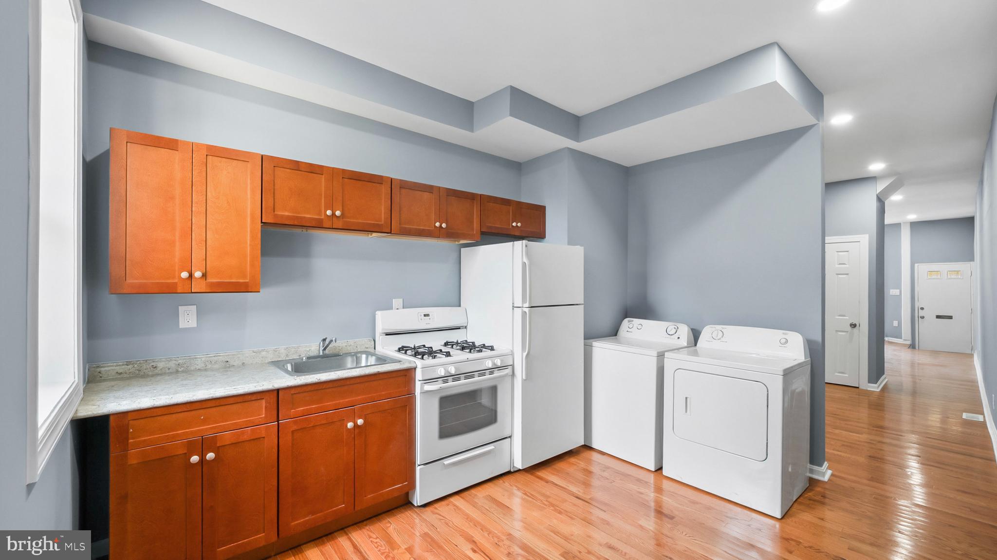 Recently renovated and thoughtfully updated, this property offers a turnkey opportunity for both investors and owner-occupants seeking long-term value. Completed months ago, the renovation was done with full permits and passed all required city inspections. The home has not been occupied since completion, offering a clean and refreshed interior ready for immediate use. Major improvements include a new electrical system, updated plumbing and gas lines, new HVAC, water heater, flooring, kitchen finishes and appliances, along with fresh paint and modern fixtures throughout. The home also includes a stove, refrigerator, washer, and no dryer. The basement provides additional usable space, and the fenced rear yard offers privacy and outdoor flexibility. With rental projections between $1,850 and $2,000 per month, this property presents strong income potential and a compelling return at the current price point. All required rental documentation is already in place, including Certificate of Occupancy, active rental license, property registration, and lead certification, allowing for immediate leasing.