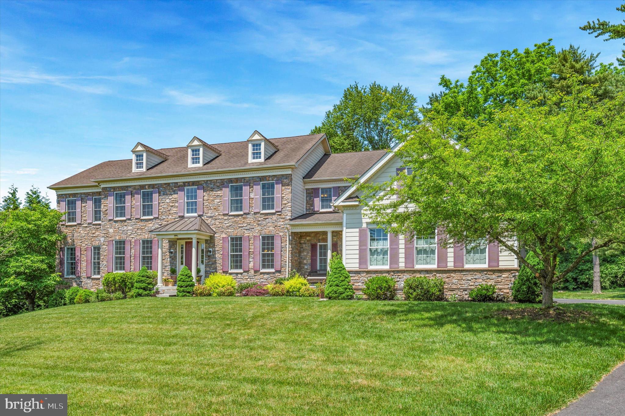 Check out the video of this amazing home. (Zillow users: find it under Facts & Features, other Interior Features, Virtual Tour). Showings start on Thursday, May 30.  Experience a lifestyle of fine living at 1 Evergreen Place in The Estates at Chadds Ford, where your home is a private haven just minutes away from any convenience you may need. This exclusive community is nestled in the heart of prestigious Chadds Ford where you will enjoy the relaxed atmosphere of the country living in a central location with superior schools, excellent shopping, fine medical facilities and a wide choice of cultural and recreational sites. This home offers 5 bedrooms, 6 full baths, a powder room and a finished walk-out basement which adds another 2200+ sqft living area and situated  on one of the premium lots in the community.  As you approach this stately home, you will notice the quality of materials, superior design and attention to detail. This Chamberlain Manor Model boasts an entry with portico, windows with artful trim and shutter and a wonderful stone and fiber cement facade. Enter through the main door and the spectacular two story foyer is complemented by a distinctive curved staircase and beautiful hardwood flooring that flows throughout the first floor.  There is also a secondary front entry that leads to the gourmet kitchen and laundry area. On each side of the foyer is the living and dining room with carefully selected details and well crafted trim package that create a signature living experience.   Through the living room is the additional great room which can be used as a playroom, gym or a place to entertain guests. Hosting a party is made more convenient with the butler’s pantry which is situated near the dining room. As you continue through the foyer, you will be greeted by a large sunken family room with a wall of windows and a stone fireplace. The private library which provides a quiet space for work and a powder room are both adjacent to the family room. The heart of this home is the well appointed kitchen that is open to the family room,  complete with a large island, pantry and a light-filled breakfast area. This chef’s kitchen features a Subzero stainless steel refrigerator, GE Monogram appliances, 6 burner stove and a double oven.  There is also a secondary staircase to the upper floor from the kitchen. Step outside onto the magnificent outdoor deck where you can enjoy your morning coffee, entertain with summer barbecues or just relax and enjoy nature in your own private backyard.  Completing the main level is a mud room/ laundry area with utility sink and a spacious three- car garage.   
Ascend the grand staircase onto the second floor which offers 5 spacious bedrooms with ensuite baths and generous closet space. The grand master suite is a luxurious owner’s retreat and offers a sitting area, vast closet space  and an opulent master bath. The spa-like en-suite master bath offers a tiled platform tub, 2 separate vanities, spacious walk-in shower and a private toilet. Wait until you see the finished lower level which is another highlight of this magnificent home. The versatile living space in the walk out basement features a 9 ft ceiling, kitchenette, bar area, full bathroom and a room which can be used as a 6th bedroom.  This area is ideal for a home theater, game room, playroom and for entertaining guests.  Enjoy all these excellent features, superior design, convenient location, outstanding schools and tax free shopping at Delaware.   The Estates of Chadds Ford is located one minute west of Route 1 and Route 202 intersection and within 15 minutes of I-95 and the Blue Route (I-476).  Commuting by train to Philadelphia is an easy 45 -minute ride from Septa's R3 Media/ Elwyn Station, just 5 minutes away.  Philadlephia Airport can be reached in 25 minutes, while the Wilmington Amtrak station is just 15 minutes away from your new home.  This is the place to live that you have been looking for.