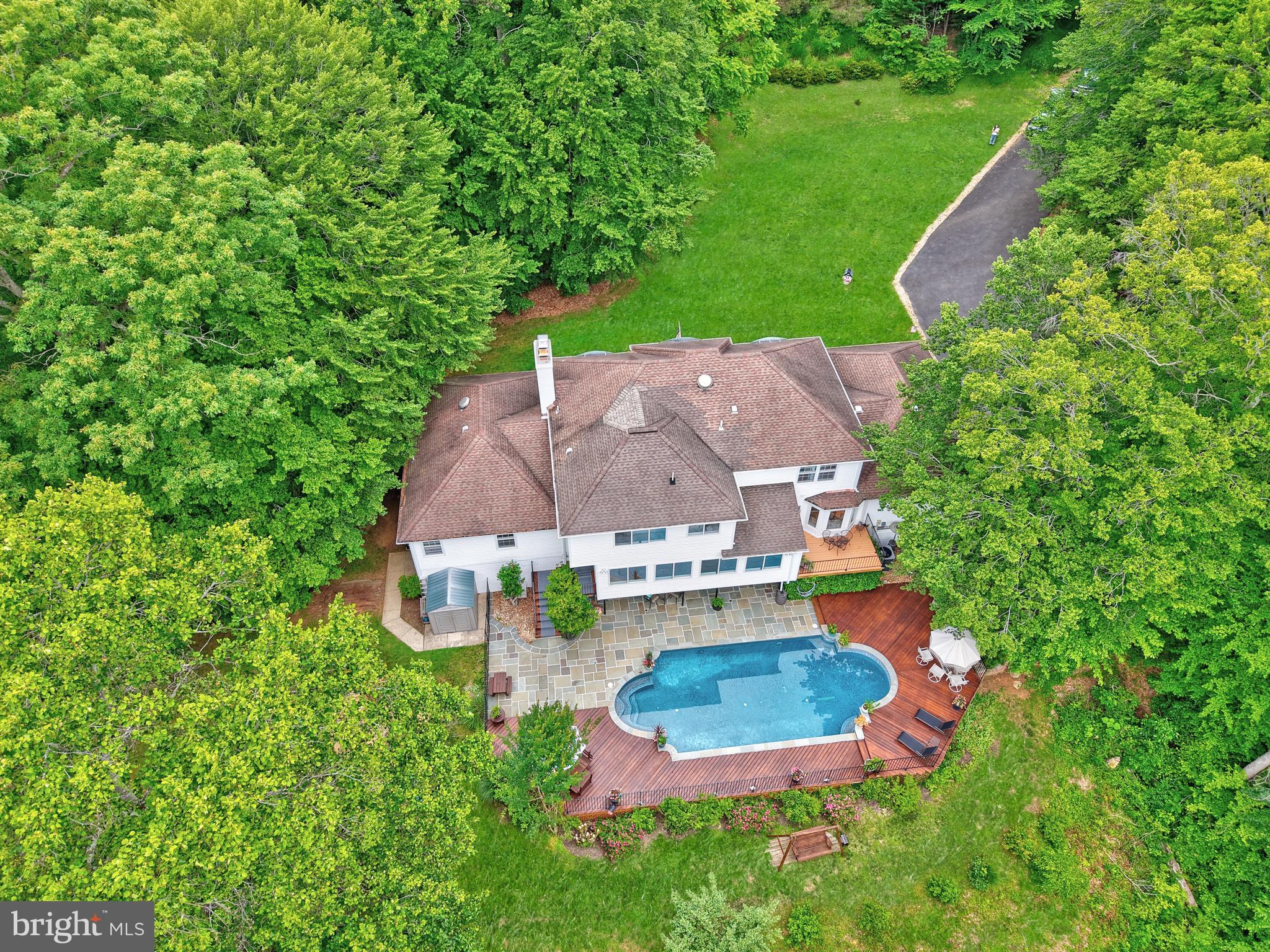 Welcome home to this AMAZING WATERFRONT PROPERTY!  Rarely available, this type of property doesn’t come up for sale often. The beautiful home has 6 BR and 4.5 BA, perfectly situated on 3.8 private acres with 600ft of Occoquan River frontage.  Nestled in a peaceful, wooded environment, this property boasts year-round river access and views. Enjoy the beauty of gorgeous hardscaping and vibrant flower gardens.  This stately home welcomes you with a newly refinished walkway. Step inside the front door and discover a formal entry that leads to a sitting room featuring a brick wood-burning fireplace and a separate formal dining room. The kitchen is a chef's dream, featuring a large island with bar seating, upgraded appliances (replaced in 2025), a coffee bar, breakfast nook, and butler's pantry. There is plenty of cabinet and countertop space too.  And conveniently located next to the office and laundry room. The kitchen flows into a spacious living room with a stunning wall of windows overlooking the pool and river.  Step out onto the newly cleaned/stained deck to enjoy the views all year round. The main level also includes a separate efficiency space with a bedroom, full bath, second kitchen, and den. Perfect for guests, in-laws, extended family to stay and have their own space. Head upstairs and you will find the huge primary suite featuring a sitting area with a fireplace, a walk-in closet, and an en-suite bathroom with a jacuzzi tub, walk-in shower, and double sink vanity. Notice all of the big windows through-out letting in so much natural light. The three secondary bedrooms share a newly renovated hall bath. Head down to the basement, you will find another family room with a bar area and woodburning fireplace, the game room, workshop/storage areas, the gym/yoga studio.  And the 6th bedroom (NTC) with another full bath.  Step out through the sliding patio doors that provide perfect access to the pool area.  This property offers abundant recreational opportunities with the heated in-ground pool for almost year round swimming, firepit, private river access with a dock for canoes, kayaks, fishing, paddleboard, sculling, powered boat with limited HP. There are vast hiking trails available in nearby Fountainhead Park and the quaint and friendly Clifton just a 10 minute drive to enjoy great food and atmosphere.   Lots of updates to include renovated upper level bathroom, front walkway replaced, freshly painted main level, exterior paint, repointing and cleaning of flagstone, staining/painting of wood deck and iron railing and new carpet in the in-law/efficiency area, a step stone path to access the sitting area over looking the water.  Don’t miss seeing this property before it’s gone!