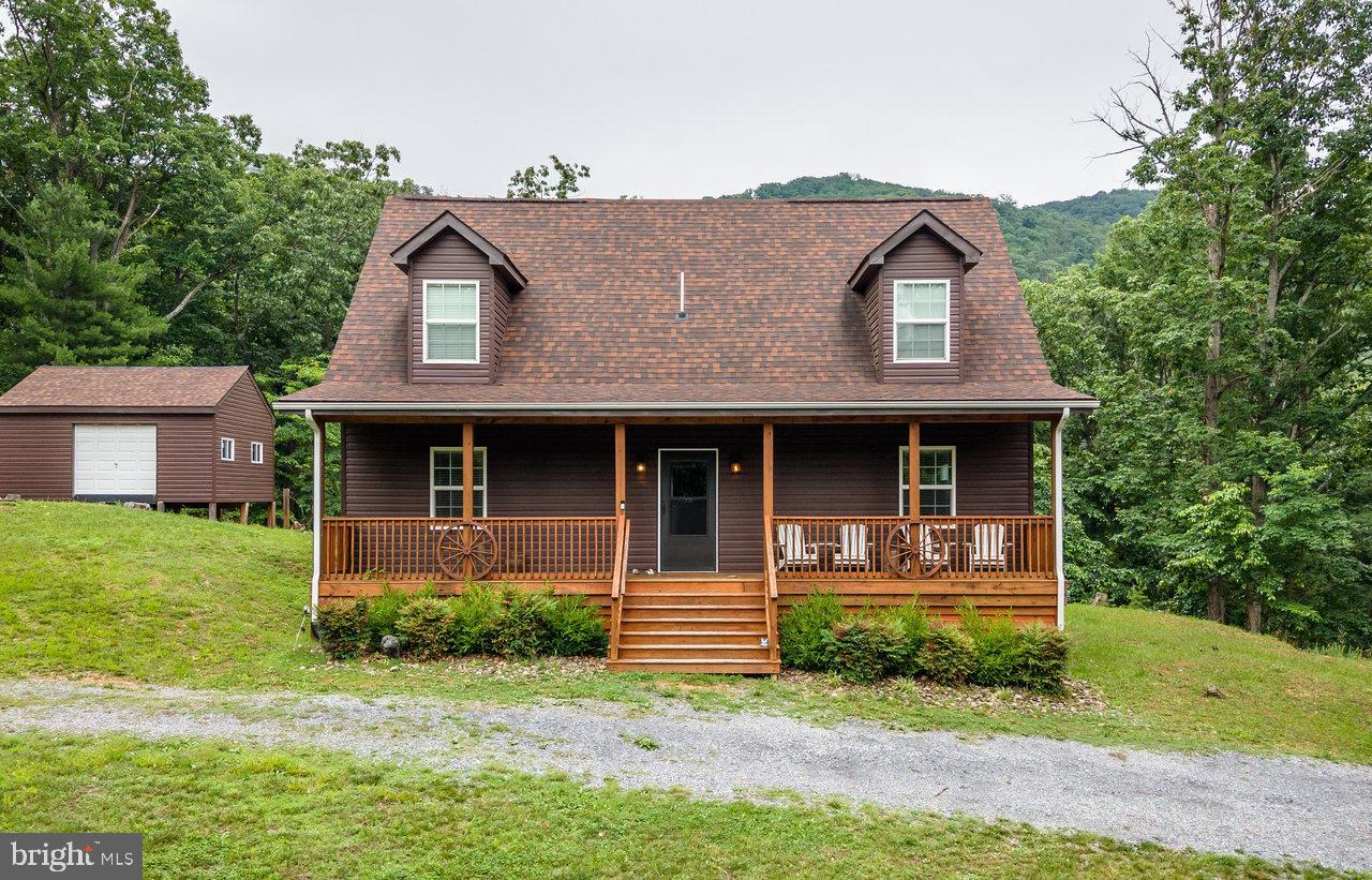 Welcome to your Shenandoah Valley escape! This fully furnished, turnkey cabin offers 1,596 sq ft of open-concept living with 3 spacious bedrooms and 2 full bathrooms, all set on a private 1+ acre lot in the scenic Shenandoah Gap community. Located just under two hours from Washington, D.C., the property is ideal as a relaxing weekend retreat or a ready-to-go short-term rental investment. The open layout creates an inviting space for gathering, while the generous bedrooms provide plenty of room for guests. Step outside to enjoy the back deck and fire pit area—perfect for spring and summer evenings surrounded by the peaceful beauty of the Shenandoah Valley! A 20' x 16' workshop offers flexible space for hobbies, storage, or a creative studio. Owners enjoy exclusive community river access just one mile away, along with access to a 400-acre private preserve for hiking, hunting, and camping. Conveniently located near the river, Shenandoah National Park, and Massanutten Resort, this property offers year-round recreation and relaxation. Whether you're looking for a mountain getaway, full-time home, or an investment opportunity, this Shenandoah Valley cabin is ready to enjoy from day one!