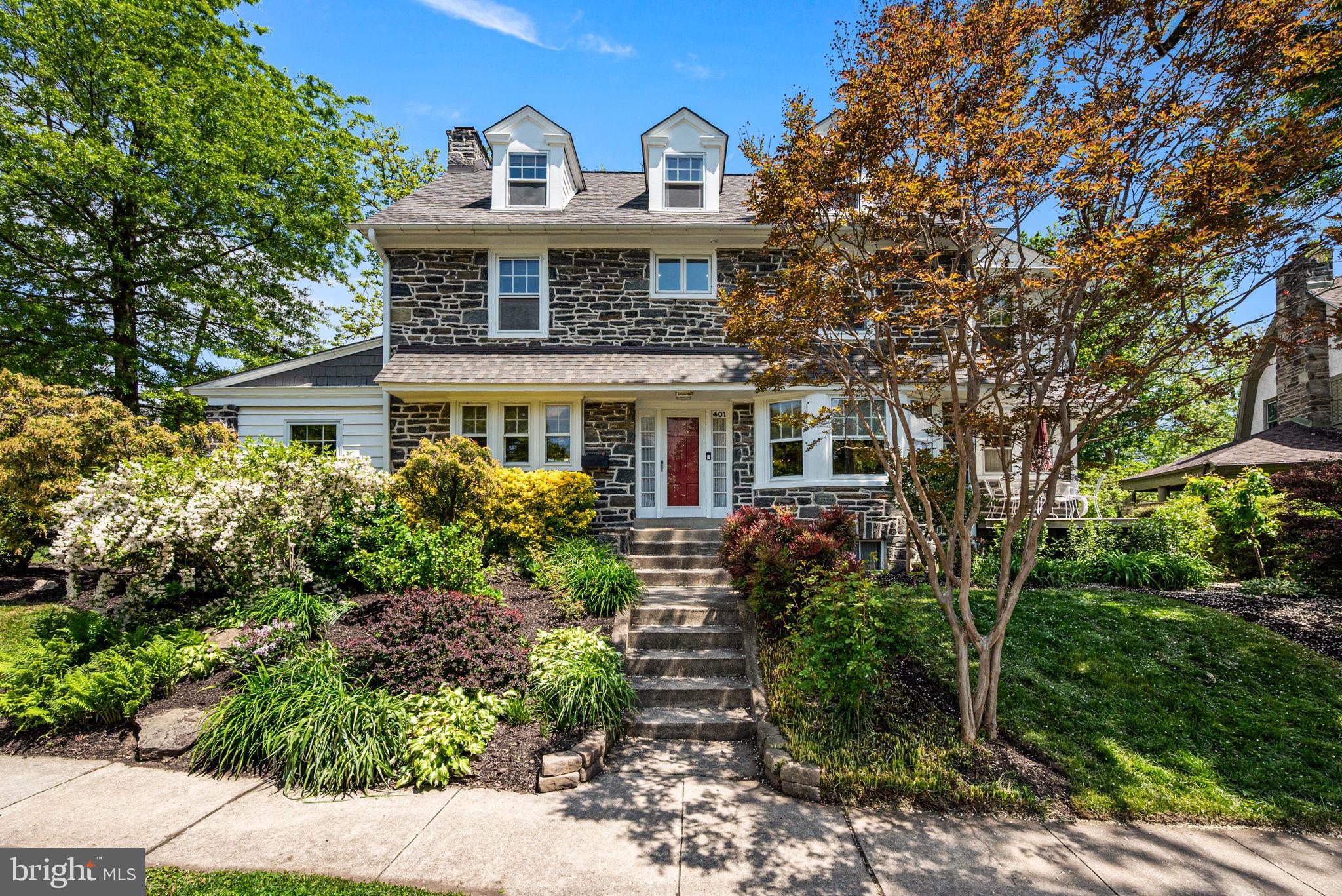 Welcome to 401 Woodside Ave, a beautiful 5 bedroom, 3 full bath, 2 half bath home located on one of the most family-friendly streets in highly desirable Narberth. Classically designed living spaces, hardwood floors, and abundant natural light create a warm and inviting atmosphere from the moment you enter. The main floor features a formal living room and a stunning music room/library that can easily serve as an office, play room, or flexible living space. The dining room is ideal for hosting large dinner parties, while the breakfast and TV room offer space for more casual meals. The adjoining kitchen, complete with double ovens, ample cabinetry and generous counter space, makes cooking a pleasure. A conveniently located powder room completes the first floor. The second floor offers three bedrooms, including the spacious primary suite with an adjoining bath and walk-in closet. The recently updated primary bathroom features a rain shower head, handheld shower, new vanity, illuminated mirrors, and a frameless glass shower door. An additional extra 6th bedroom has been transformed into an exceptional walk-in closet with a center island and granite countertop that adjoins the primary suite. Two additional bedrooms are served by a center hall bath. The larger guest bedroom, currently used as an office, also includes its own powder room. The third floor includes two additional bedrooms and a central hall bathroom, offering flexibility for private guest quarters, home offices, or creative spaces. Outside, the property provides wonderful opportunities for relaxation and entertaining. Enjoy morning coffee, gatherings with friends, or gardening in the private side yard that balances tranquility with community charm. The large deck offers plenty of room for grilling and outdoor entertaining with easy access to the kitchen, and can be reconfigured as a fenced play area. Parking and storage are well accommodated with a tandem single door extra long garage that can accommodate up to two cars. Located within the award winning Lower Merion School District, 401 Woodside Ave is just a 5 minute walk to the SEPTA Regional Rail and Narberth’s charming downtown, parks, shops, and restaurants. Easy access to Center City Philadelphia and nearby universities makes commuting convenient while enjoying the neighborly small town character Narberth is known for. With its exceptional combination of space, functionality, and sociable location, this home presents a rare opportunity you will not want to miss. Please note, all knob and tube wiring has been replaced in the home.
