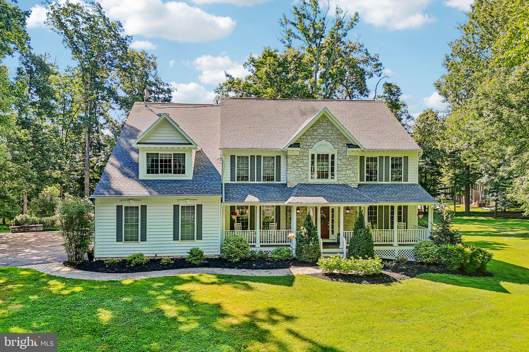 <b>The Long and Winding Drive</b><br> <i>A private retreat hidden from the everyday.</i><br><br>

A long approach from Frederick Road creates a sense of anticipation rarely found in today's homes.  Nestled on 3 private acres, partially wooded and hidden from passing traffic, this timeless colonial offers the privacy and tranquility of a country estate while remaining just minutes from Routes 97 and 70. 
As the home comes into view, its welcoming front porch and picturesque setting hint at the exceptional living spaces that await inside.<br>

Step inside and discover a home designed for both grand entertaining and comfortable everyday living.  The dramatic two-story family room is the heart of the home, where a breathtaking waterfall of windows fills the space with natural light and showcases views of the surrounding property.  Complementing the soaring ceiling is a spectacular floor-to-ceiling stone fireplace that serves as the room's striking focal point, adding warmth, character, and timeless appeal.  A private library provides the perfect retreat for reading, working, or quiet reflection, while a graceful dual staircase adds both beauty and functionality, connecting the main living spaces with the private quarters above. <br>
Upstairs, the primary suite offers a true owner's retreat, complete with a luxurious bath and an adjoining sitting room originally designed as an optional fifth bedroom.   This versatile space is ideal as a nursery, fitness room, hobby room, or additional bedroom.   A private en-suite bedroom offers comfort and privacy for family or guests, while two additional spacious bedrooms are served by a beautifully appointed hall bath, creating a comfortable and functional layout for everyday living.  <br>

The finished lower level offers exceptional flexibility with a bedroom, full bath, and generous living space ideal for extended family, guests, an au pair, or a future in-law suite.  With its separate entrance, the possibilities are endless.  Also found on this level is a custom temperature-controlled wine cellar with capacity for approximately 335 bottles.  Behind its elegant glass-paneled door, this distinctive space was thoughtfully designed to preserve and showcase a prized collection under ideal conditions.  Complete with a humidor, it is a rare and memorable luxury feature that adds both character and sophistication to the home's already impressive list of amenities.  A cozy propane fireplace further enhances the lower level, creating an inviting atmosphere for entertaining or relaxing year-round. <br>

Outdoor living is every bit as impressive as the interior.  Two screened porches invite you to enjoy the changing seasons, while the expansive Trex deck provides the perfect setting for entertaining.  The covered gazebo, complete with a fireplace, creates a warm and inviting gathering space for family and friends.  A charming treehouse adds a touch of whimsy to the property, while the electrified barn/shed provides additional flexibility for hobbies, storage, or workshop space.  Whether hosting large gatherings or enjoying a quiet evening under the stars, these outdoor spaces were designed to be enjoyed year-round. <br>
Offering 5 bedrooms, 4 full and 1 half baths, timeless architectural details, remarkable entertaining spaces, and a setting that feels a world away from the everyday, this is more than a home—it's a destination.<br>

<b>The journey is worth it.</b>