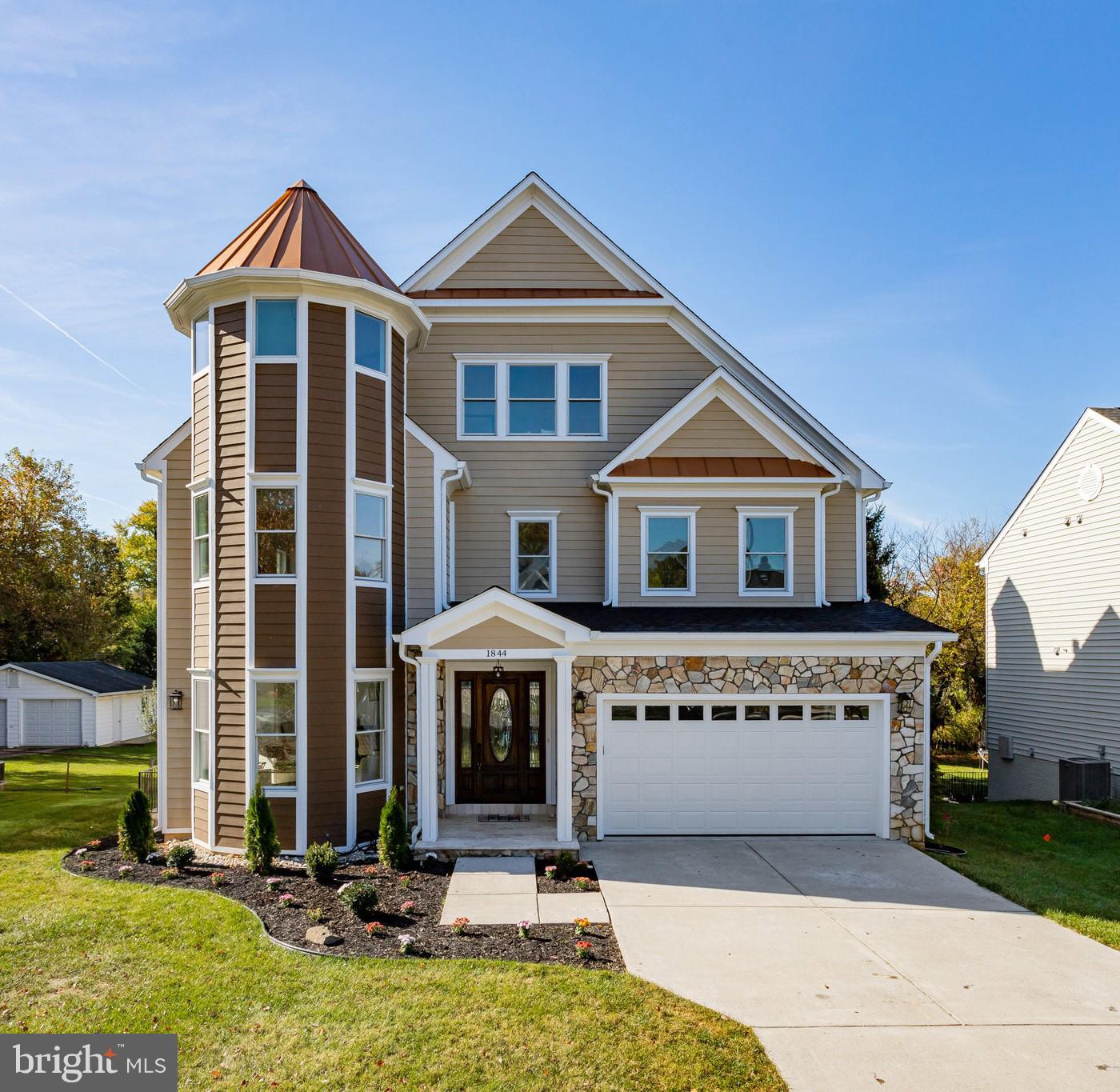 **Stunning Modern Victorian in Falls Church – The Home of Your Dreams Awaits** Presenting an unparalleled opportunity to own a Modern Victorian masterpiece in Falls Church, Northern Virginia. This four-level architectural marvel perfectly balances classic elegance with contemporary luxury, offering a lifestyle of comfort, charm, and sophistication in one of Northern Virginia’s most desirable communities. Set against an expansive yard that showcases natural beauty, the home exudes curb appeal with its stately octagon turret crowned in gleaming copper roof panels and its distinguished stack stone façade on both the front and back of the home. Stepping through the grand mahogany front door, adorned with beveled glass and matching sidelites, you’ll be captivated by the opulent entryway, graced by an impressive 31-foot marble floor that flows seamlessly through the heart of the main level. The living and dining rooms, featuring semi-octagon bay windows, bathes in natural light, creating a bright and inviting space. The family room, with a gas fireplace framed by sleek black slate, is the perfect spot to unwind in style. Recessed lighting and pre-wired rooms throughout the home ensure every space is designed for modern convenience and comfort. The gourmet kitchen is a chef’s dream, boasting custom elevated panel cabinetry with glass-front displays, gleaming granite countertops, an expansive island, a top-of-the-line 6-burner stove with griddle, double ovens, a built-in refrigerator, a walk-through butler’s pantry, and a spacious walk-in pantry. Thoughtfully appointed with a tile backsplash, oversized range hood, and a sunlit breakfast room leading to the expansive deck, this kitchen is equally suited for entertaining or creating intimate meals. Every detail on the main level speaks to refined taste, with wainscoting, crown molding, chair rail, and solid mahogany raised panel doors with matte black hardware. The powder room, complete with a pedestal sink and matte black fixtures, offers convenience, while the coat closet and garage access complete the thoughtful layout. Ascending to the second floor, you’ll find three beautifully appointed bedrooms. The primary suite is a luxurious sanctuary, featuring a 2 custom built-in closet system and a lavish ensuite bathroom with double vessel sinks, a frameless rain glass shower, a jetted soaking tub, and a picturesque window offering serene views. Two additional bedrooms, each with their own private baths and walk-in closets, provide comfort and privacy, while a dedicated laundry room and hall closet add practicality. On the top floor, the great room is nothing short of spectacular, with a large arched window, angled ceilings, and charming gabled dormers. Built-in seating invites you to take in treetop views and relax in comfort. Adjacent to this room, a bedroom with soaring 29-foot cathedral ceilings awaits, while the fairy-tale-inspired sitting room, set within the octagon turret, offers a cozy retreat. The expansive lower level is designed for entertainment and versatility, featuring a recreation room, media room, additional bedroom, full bathroom, and a wet bar complete with glass-front cabinets, built-in wine rack, wine refrigerator, and granite countertops. This is more than just a house—it’s a statement of elegance and an embodiment of luxury. Don’t miss your chance to own one of Northern Virginia’s finest homes. With its breathtaking design, masterful craftsmanship, and unparalleled amenities, this Modern Victorian in Falls Church is a rare find and is ready to welcome you into a life of unparalleled comfort and style. Don’t let this once-in-a-lifetime opportunity slip by; make this extraordinary home yours today!