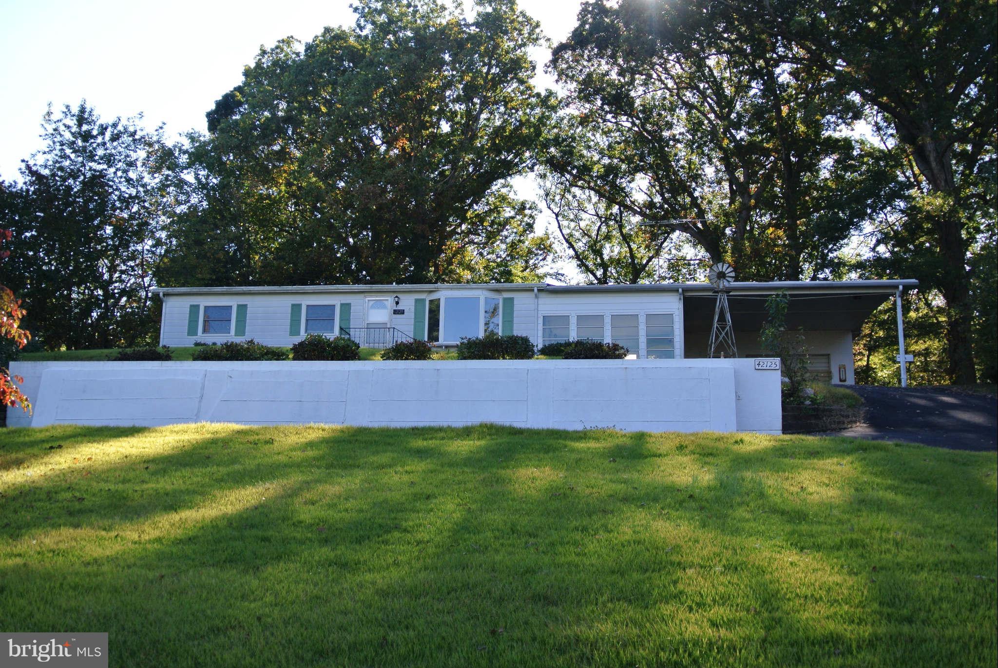SPRAWLING RAMBLER NESTLED ON AN ALMOST HALF ACRE OVERLOOKING THE PATUXENT RIVER. OPEN FLOOR PLAN FEATURES 3 LG BEDROOMS, 2 FULL BATHS, CATHEDRAL CEILINGS AND TONS OF STORAGE. (MSTR BR CAN CONVERT TO 2 BR) MANY RECENT IMPROVEMENTS; ANDERSEN WINDOWS, CENTRAL A/C, CARPET, PAINT AND DRIVEWAY. LG ENCLOSED PORCH, CARPORT AND DOUBLE GARAGE/WORKSHOP W/220v. HOME WARRANTY INCLUDED.