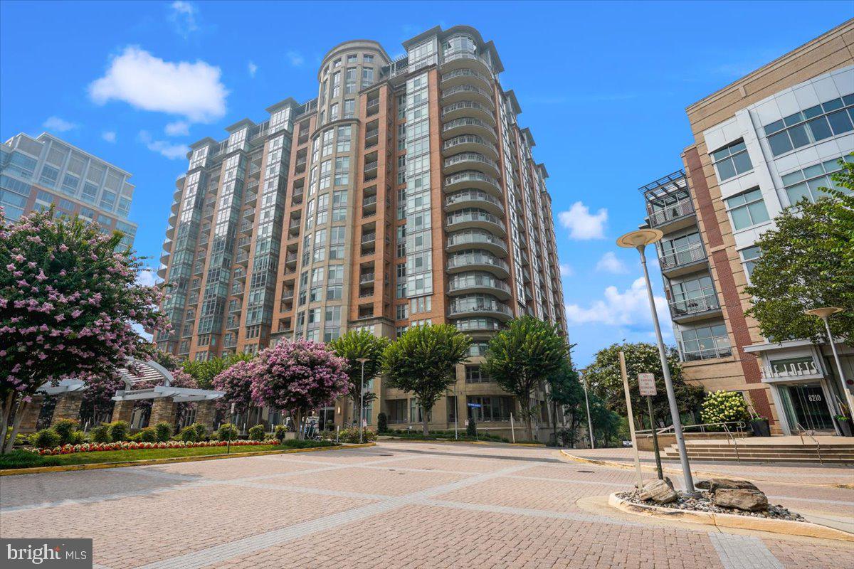 Great opportunity to have the best of both worlds — urban living in the heart of Tysons, yet tucked away in the quieter, more residential setting of One Park Crest. This lovely 1-bedroom plus den, 2-bath condo is located on the 16th floor and offers beautiful unobstructed northern views toward Sugarloaf Mountain from the wall of windows in the family room and the full-length balcony.  The kitchen is truly a standout feature and cannot be overstated. Professionally renovated by Case Design with over $170,000 in high-end upgrades, it features an impressive 8-foot center island with brilliant blue Volta quartz countertops and flushed with a built-in wine refrigerator, high-end appliances, custom cabinetry graced with elegant glass-front upper cabinets, and three overhead cabinets with glass pocket windows. Hardwood floors add warmth and sophistication throughout the living areas. Tall windows and a full-length balcony create a bright, open feel and showcase the expansive views. The primary suite features a luxurious walk-in shower with pebble stone flooring, granite countertops, and a custom bench seat. The guest bathroom is virtually identical in design and finish, creating a seamless and elegant flow throughout the home. The den includes built-in shelving and is ideal for a home office or guest space.  It is conveniently located just steps from the elevator or exit door.  A washer and dryer are located within the unit. Residents enjoy exceptional amenities, including a rooftop pool, state-of-the-art fitness center, elegant conference room, guest suites,  24-hour concierge service, and pet friendly.  Enjoy a premier Tysons lifestyle within close distance to The Boro, Whole Foods Market, Wegmans, top restaurants, and the Silver Line Metro, with easy access to Tysons Galleria, Washington, D.C., and Washington Dulles International Airport. Located in the McLean High School district, this rare opportunity offers luxury, convenience, and location all in one.