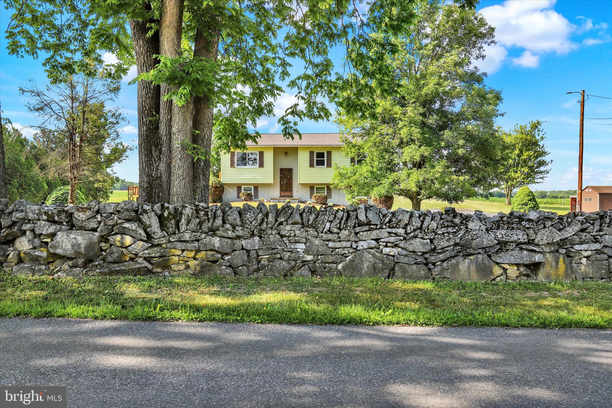Enjoy the country living in this 3 bedroom, 2 full bath bi-level that sits on a 1.6 acre double lot.  Each lot is .8 acres in size and offer great possibilities for added recreation space and potential outbuildings.  Beautifully surrounded by a stone wall at the entry and farm fields to the rear, this Newville home is full of potential.  Kitchen features granite countertops, large dining area and access to the rear composite deck.  Main level boasts a spacious bathroom and 3 bedrooms.  Lower level of home features a family room space, 1 full bath, laundry and access to the 2 car garage. Previous above ground pool deck is in place if new owners want to complete for a large deck space or install a new above ground pool. All this plus a metal shingle roof with a lifetime transferable warranty.  Welcome home.
