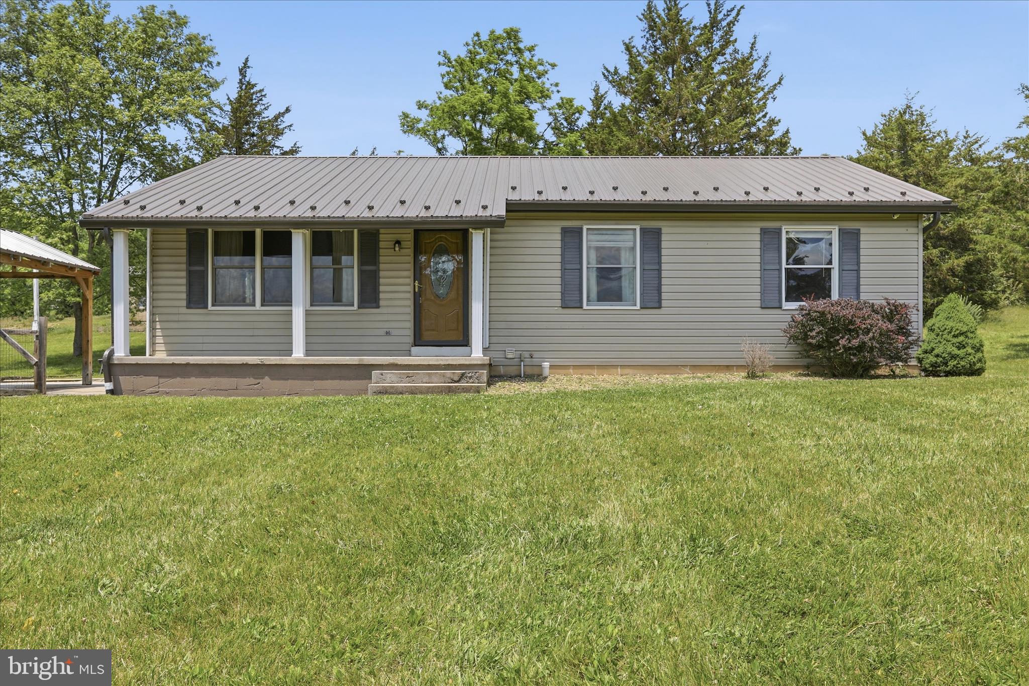 Nestled on a spacious lot in Hancock, MD, this rancher offers the perfect blend of comfortable one-level living and peaceful country surroundings. Featuring 3 bedrooms and 2 full baths, this home provides a functional layout designed for everyday living. The living room and dining room feature luxury vinyl plank flooring, creating a durable and inviting space for gathering and entertaining. The primary bedroom includes an attached private bath.

Additional highlights include a covered front porch, mountain views, a 1-car detached garage, an unfinished basement providing excellent storage or future finishing potential, and a metal roof replaced in 2021. The home is equipped with a whole-house UV water purification and filtration system for enhanced water quality. With plenty of outdoor space to enjoy, garden, or simply take in the surrounding countryside, this property offers endless possibilities.