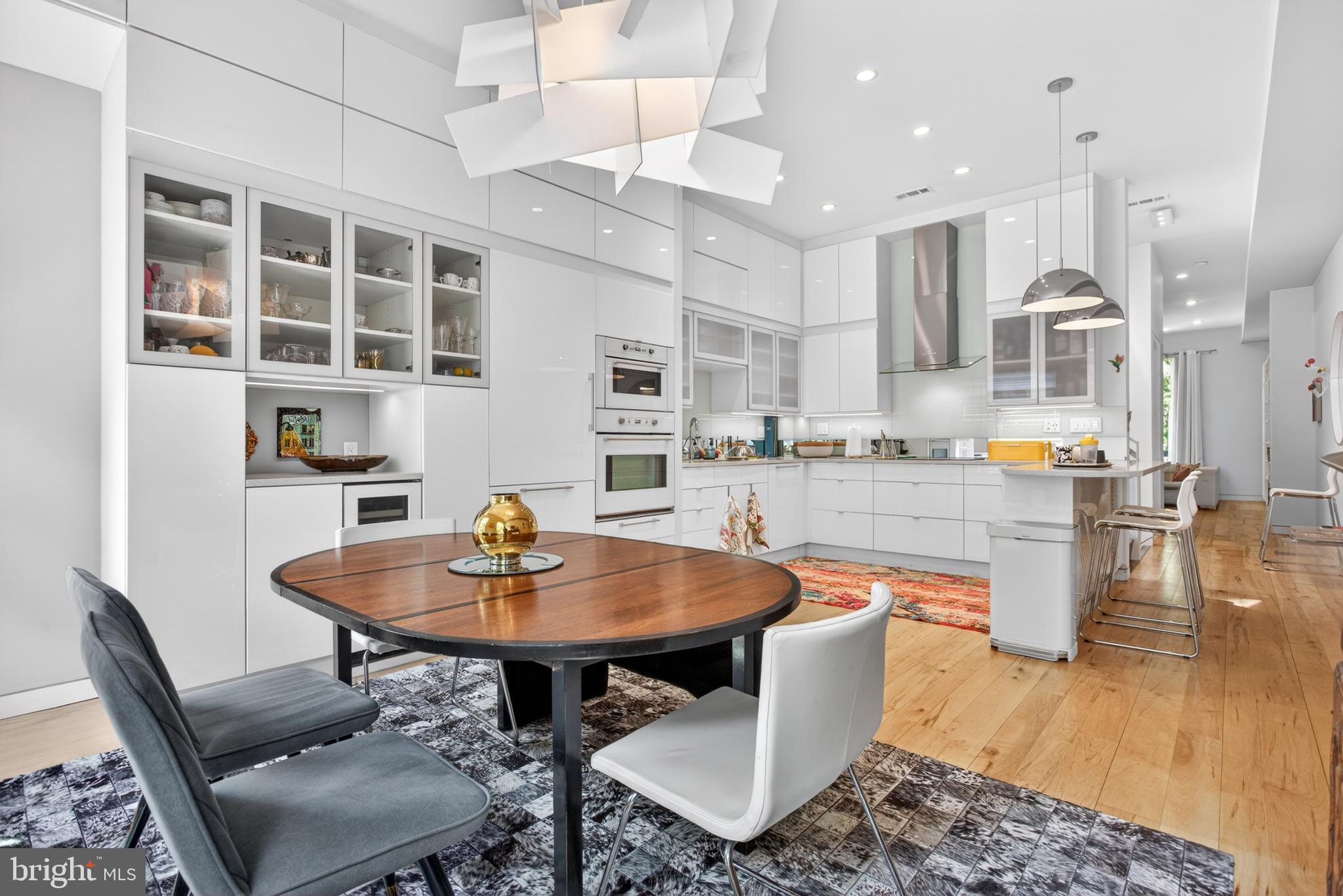 Style, sophistication and exquisite taste have transformed and elevated this Center City home into an urban oasis rarely found. At the border of Rittenhouse & Graduate Hospital, this home was spectacularly remodeled in 2015 with a French contemporary flair by its visionary owner. From the gorgeous kitchen with floor to ceiling cabinetry to the primary suite with an enviable en-suite bath, the beauty of this home catches your eye with every step. 
Your private 1-car garage has abundant bonus storage shelving and cabinets and provides entry directly into your home. 
Lovely tiles lead you from the art-deco vestibule down the contemporary hallway into the first level room with gorgeous reclaimed hardwood floors. This space, with a separate entry, can serve as a third bedroom, an in-law, nanny or guest suite, or as an office thanks to a CMX2 zoning. A soundproofed ceiling adds to the privacy of this room. A private vestibule, a full bathroom and a large shelved closet are part of this spacious suite. Flowing from its huge sliding doors, the private garden features an acacia deck and offers a rare welcoming tranquil serenity. Cookout entertain or simply relax in the summer or cuddle up next to the fire pit on chilly spring and fall evenings. 
Entering the rest of the house through a clever pocket door, you discover the unique and grandiose perforated stainless steel stairwell as you hang your wrap in the self-lighting coat closet.  Take in its striking lighting from the basement to the third floor, illuminating your way up to the main floor living space and into the magnificent open kitchen including a large dining area. Counter space and storage cupboards abound. The sublime quartz countertops are further highlighted by the one-of-a-kind painted mirror backsplash. The induction cooktop vents into a professional Miele hood above.  A top-notch Bosch dishwasher, Whirlpool convection oven and built-in microwave lead you to a gorgeous Liebherr refrigerator, all blending together perfectly.  Just beyond is a bar area with a convenient built-in wine fridge. Under-cabinet lighting adds to the luminosity and dramatic effect of the space, together with the counter’s remotely controlled LEDs for you to  express whatever color your mood desires. This part of the counter with its bar stools will be perfect for gathering guests while you’re cooking. It also features a recessed drinking nook for pets to join in the festivities. Make your way past the elegant powder room to your huge great room.  Double tilt-and-turn glass doors offer a gaze down on the patio area. A wall of shelving is perfect for displaying your favorite books and collectibles. A large hidden closet provides ample storage. 
Head up to the magnificent primary suite. Located in the rear portion of the home it too overlooks the lovely garden with tilt-and-turn windows. A huge wall of closet space provides for a large wardrobe. The en-suite luxury bath has double sinks, a private commode closet with built-in TOTO bidet, radiant heat flooring and a massive shower area with misting, rainfall, handheld euro-style, wall and ceiling shower features. The landing area provides even more storage and an uber-convenient stacked washer and dryer behind newly installed louvre doors. The third full bathroom is located next to the guest bedroom featuring its own huge finished closet space. A mini-split system on this level enhances heat and air conditioning. 
As if this home wasn’t ample enough there is also a large finished basement. Currently utilized as a workout area, it could easily be transformed into a home theater. Mechanicals are tucked into their own private closet and a wall of wine racks hold more than 150 bottles for wine connoisseurs. 
Pet lovers will rejoice with a dedicated drinking/feeding recessed zone under the kitchen counter and a custom doggy door in the 1st floor room. 
The owner had a pre-listing inspection completed and addressed. This home is truly magnificent.