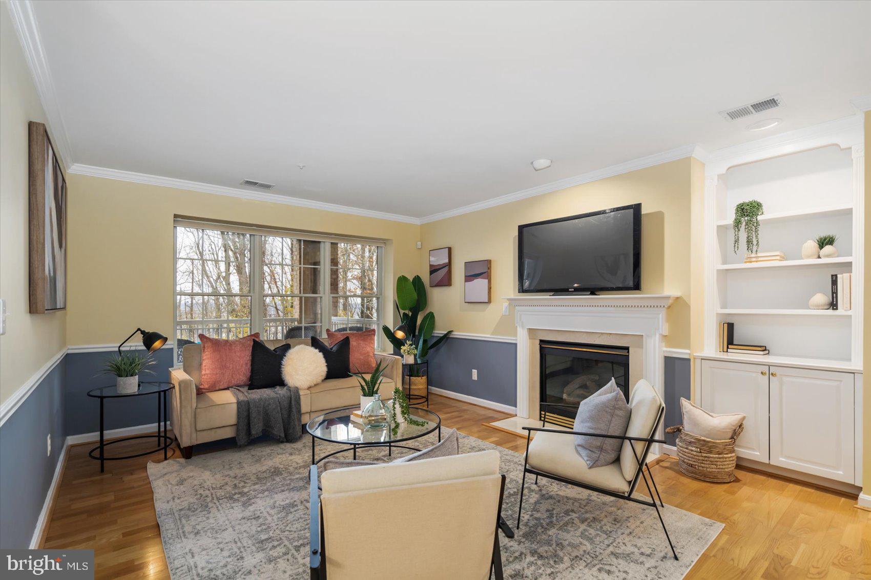 Welcome to this meticulously maintained first floor condo in well-sought out community of Rosslare Ridge. This like-new 2 bedroom, 2 full bathroom includes many upgrades and shows pride of ownership with over 1757sq ft! Enter the property and be greeted with natural light that beams throughout the home. The living room includes hardwood flooring, gas fire place, chair railings, crown molding and built-in shelving unit for easy storage. The separate formal dining room provides for all your entertaining needs. The freshly  painted kitchen includes granite counter top, ample cabinetry, breakfast bar and sunroom which is a perfect location for meals with access to the elevated patio with  views of nature with private and security. This home has two spacious bedrooms including a primary bedroom en suite with an attached bonus office & with large walk-in closet.