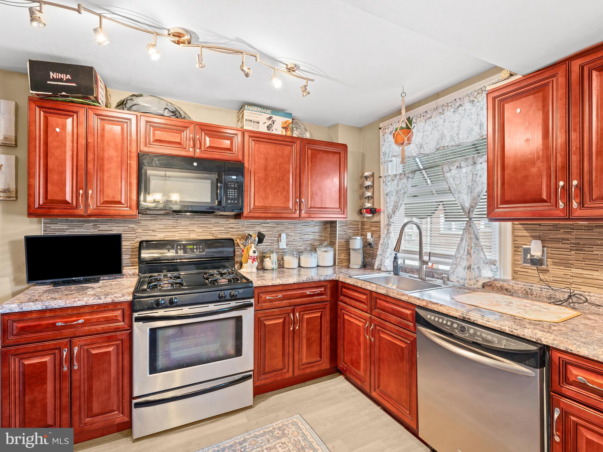 This is a must see! You won't be disappointed! Schedule your appt today! This home exudes pride in ownership.  Enter this gorgeously arranged living room that flows perfectly through to the good size dining room, which is off the beautifully updated kitchen. This lovely home features beautiful hardwood floors throughout. Home has an updated kitchen w/Stainless Steel Appliances, Granite Countertops w/Mosaic Tile Backsplash and Tiled Flooring. This gorgeous 2-bedroom, 2 full bath home is spacious with a large finished basement which could also serve as a 3rd bedroom for family, guest, an office, playroom, etc. and there's a full bath with shower.  Washer & Dryer located in basement. The basement exits to the rear one car parking space. New Roof with 12 yrs guarantee! Close to public transportation, shopping and restaurants.