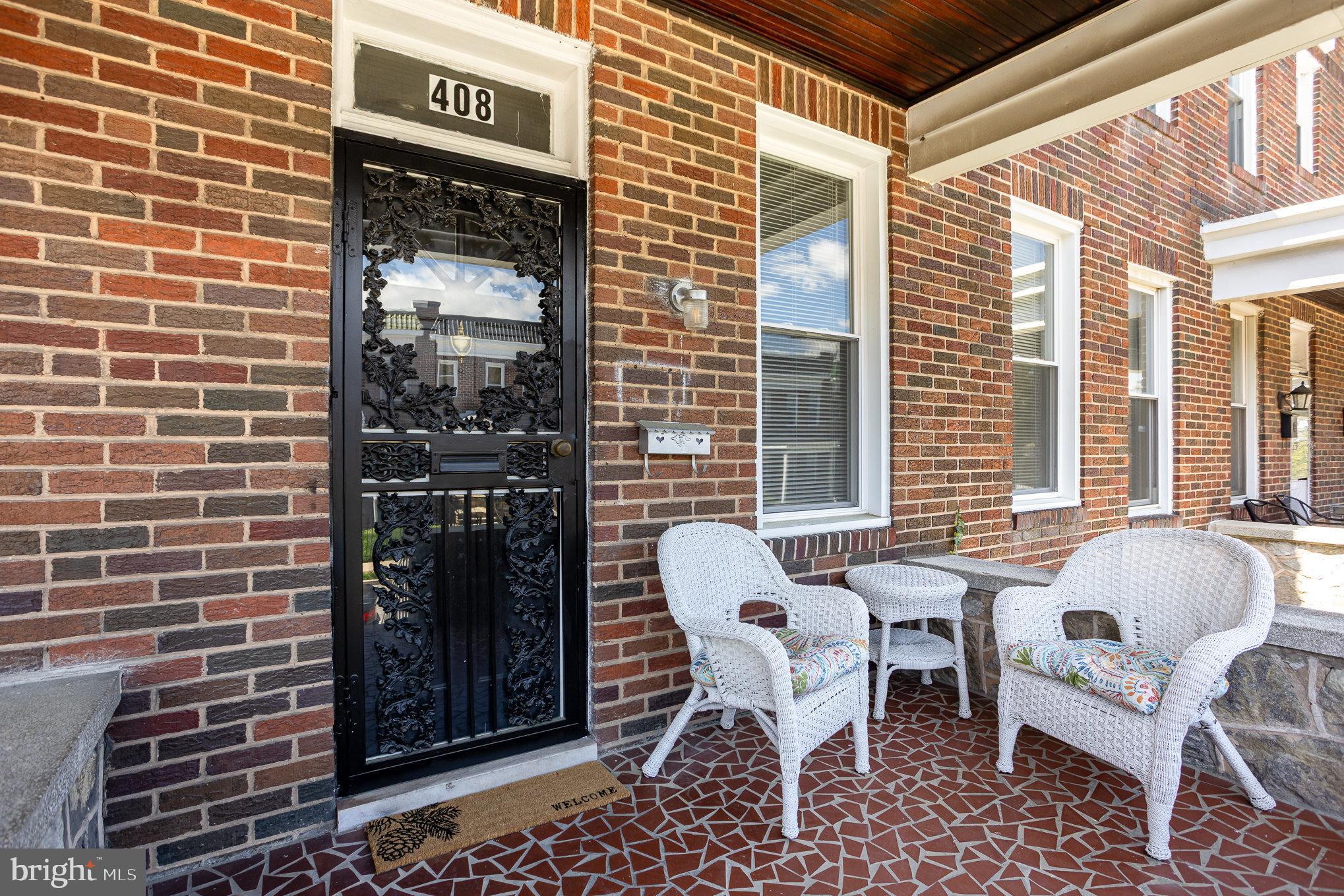 This beautiful freshly painted, porch-front rowhouse, with Central Air, offers the perfect blend of character & contemporary updates. Step through the foyer, and into the elegant French doors lead into a cozy living room with mahogany inlaid hardwood floors, then flow into a separate dining area—ideal for hosting formal dinners. The stylish, modern kitchen is built to impress with Quartz countertops and stainless steel appliances, including a refrigerator, range, dishwasher, and pot racks—perfect for cooking and entertaining. You can circle back to the foyer from the kitchen.

Upstairs, you’ll find 3 generously sized bedrooms with newly refinished hardwood floors and a full bath. The partially finished lower level offers flexible space for a family room, office, 4th bedroom or workout area, along with a half bath, laundry, and additional storage. Out back, enjoy a private fenced yard and covered rear porch—a great setup for BBQs, outdoor dining, and letting pets play. Stay comfortable year-round with central air (2026) and efficient, recent radiator heat.

With central AC installed in 2026, gleaming hardwood floors (refinished 2025), and abundant natural light streaming through modern windows (2023), this home is move-in ready and awaits its new owner.

Ask us about down payment and closing cost grants—you might be able to own this home for less than you pay in rent! Schedule your showing today!