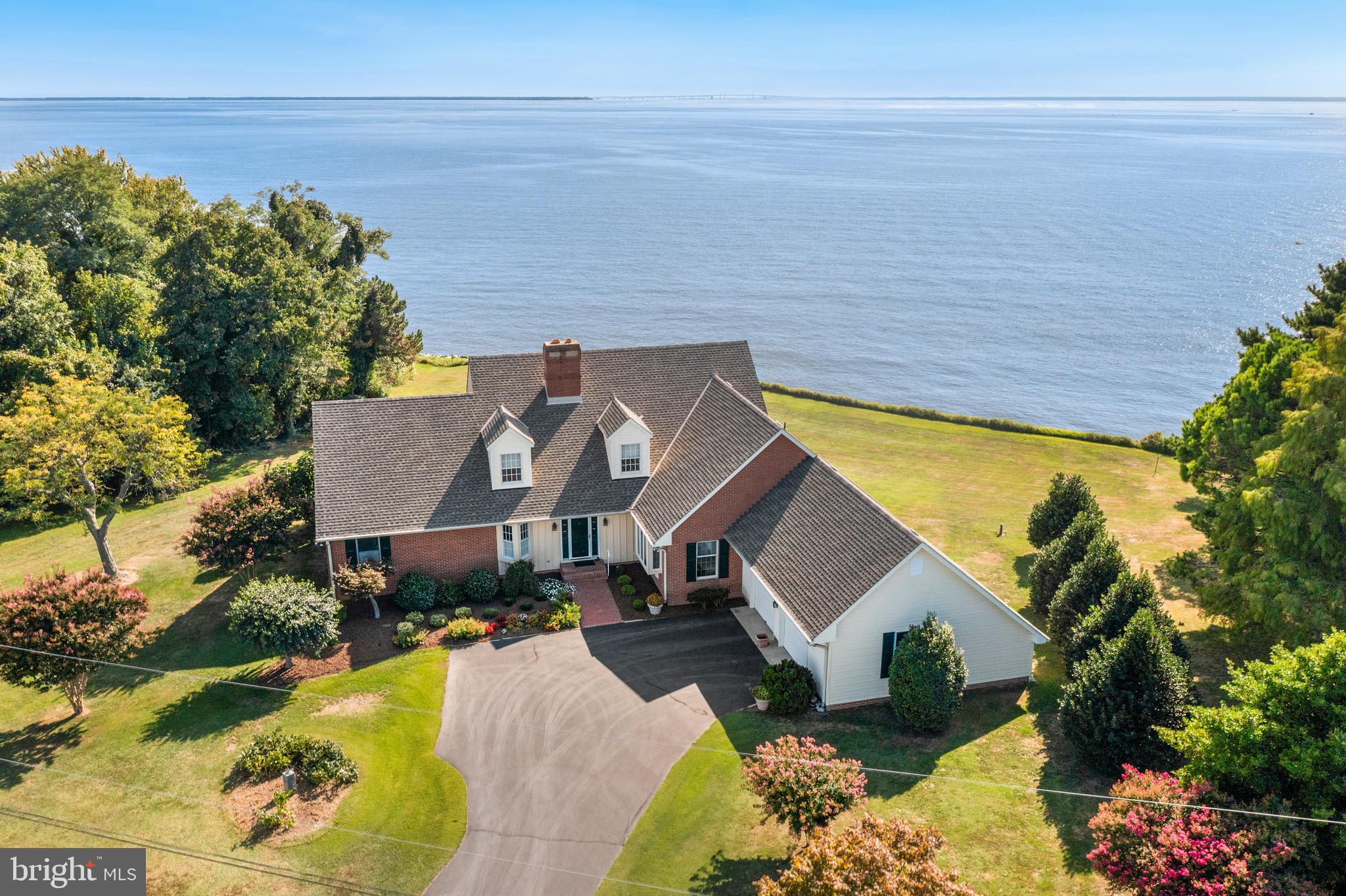 MAJOR PRICE REDUCTION. Welcome to your custom-designed waterfront retreat! This stunning home, set on 1.13 acres, offers an expansive 200 feet of pristine Chesapeake Bay shoreline and breathtaking 180-degree views stretching from the Chesapeake Bay Bridge to Baltimore. Situated on an elevated lot outside the flood zone, this property ensures peace of mind and uninterrupted tranquility. Step inside to discover exquisite custom millwork and cherry hardwood floors that grace the entire home. The modern kitchen features a central island and seamlessly connects to the dining area and sunken family room. Here, a cozy fireplace and built-in cabinetry create a warm, inviting atmosphere. Enjoy effortless indoor-outdoor living with slider access to a newer, expansive composite deck equipped with cable railing, a covered section, and an additional awning for extra shade. The main level includes two well-appointed bedrooms, including a luxurious primary suite with direct deck access, a spacious walk-in closet, and an elegant bathroom. The second bedroom on this floor is currently utilized as an office. Upstairs, you’ll find two additional guest bedrooms and a full bathroom, perfect for family and friends. An unfinished, dry basement offers ample storage space, while the large mudroom with laundry provides convenience right off the oversized 2-car garage, which boasts premium garage door openers. Additional features include a backup generator and tinted windows on the waterside for enhanced comfort. With a new roof installed in 2021 and beautifully landscaped grounds, this home is in immaculate condition and ready for you to enjoy. Just 5 minutes south of Rock Hall. Don’t miss the chance to experience unparalleled waterfront living. Motivated sellers. Schedule your private showing today!