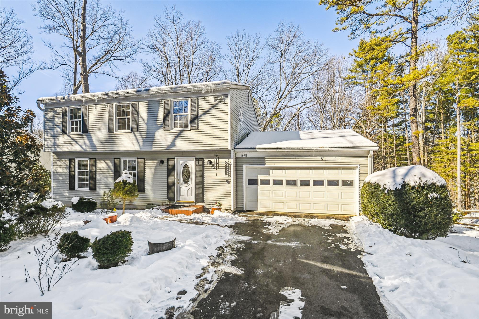 BACKING TO MATURE TREES IN DESIRABLE RESTON! THIS 4-BEDROOM, 2.5-BATHROOM HOME WITH A 2-CAR GARAGE WELCOMES YOU. THE FOYER FEATURES CHAIR RAILING, A COAT CLOSET, POWDER ROOM, AND ACCESS TO THE TWO-CAR GARAGE. THE WARM AND INVITING FAMILY ROOM, WITH NEUTRAL CARPETING, SHOWCASES A WOOD-BEAMED CEILING AND CHAIR RAILING WITH BEAD BOARD. IT OPENS TO A SUNLIT ADDITION WITH A WOOD STOVE AND TWO DOORS FOR ACCESSING THE DECK AREA.  ENJOY COOKING IN THE EAT-IN KITCHEN WITH WOOD LAMINATE FLOORS, AND A DOOR THAT LEADS TO THE DECK, MAKING GRILLING EASY! ENTERTAIN IN THE FORMAL LIVING ROOM FEATURING A CUSTOM BUILT IN. ASCEND UPSTAIRS TO THE PRIMARY SUITE WITH TWO CLOSETS, A BAY WINDOW, AND AN ATTACHED PRIMARY BATH WITH A STAND-ALONE SHOWER AND VANITY. THREE ADDITIONAL BEDROOMS AND A FULL BATH WITH TUB/SHOWER COMBO ARE LOCATED ON THE UPPER LEVEL, ALONG WITH A LAUNDRY CHUTE. THE UNFINISHED WALK-OUT LOWER LEVEL INCLUDES A LAUNDRY ROOM WITH WASHER/DRYER AND AWAITS YOUR DESIGNER TOUCHES!