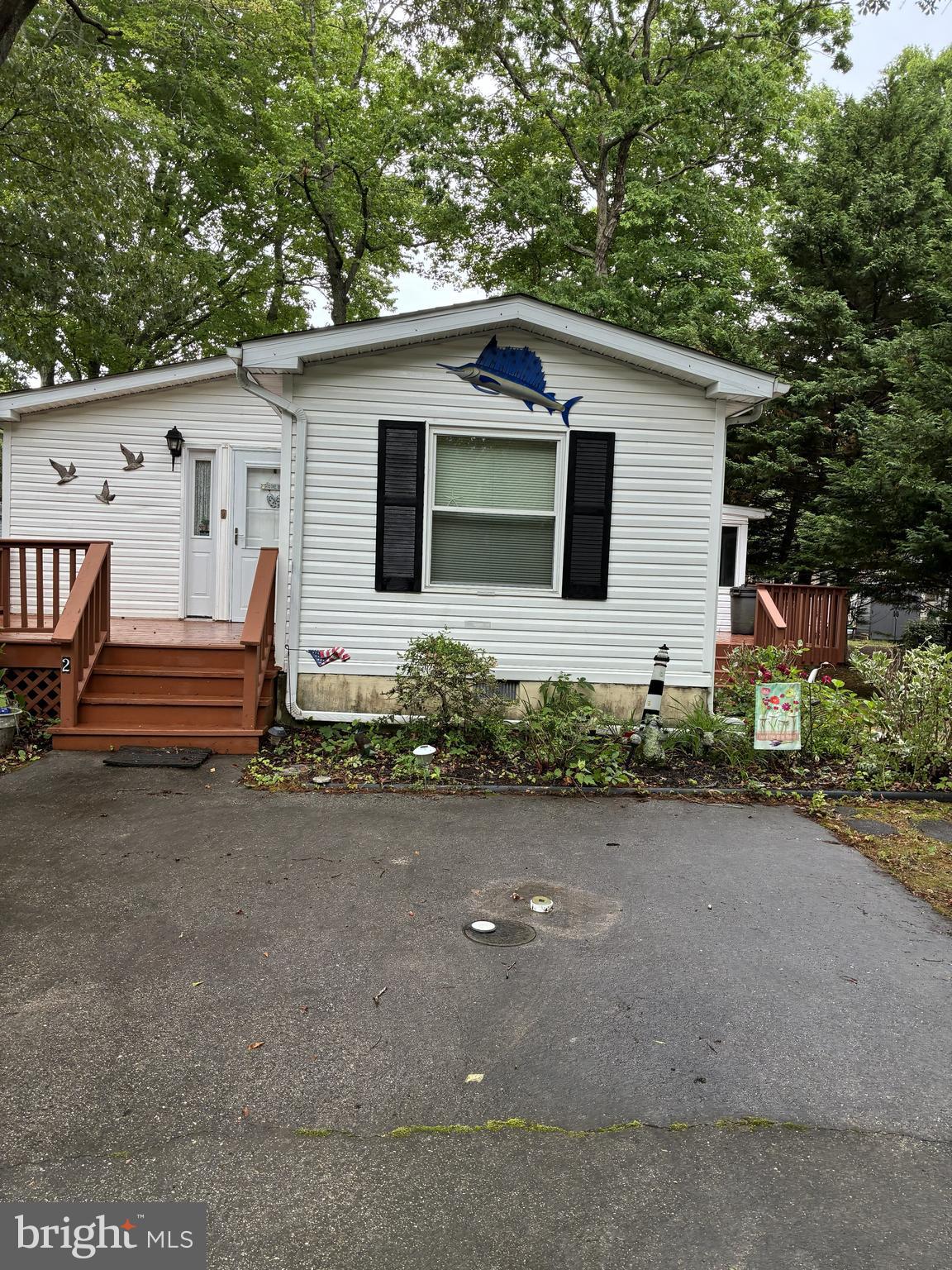Professional Photos coming Soon. This 2 bedroom 2 bath beach retreat is perfect for someone looking to live at the beach year round or have a great vaction spot.  Enjoy this home that shows true pride of ownership in the quiet Mystic Harbour Community. This home features a large living area with open kitchen perfect for entertaining. There is a beautiful oversized suroom off the kitchen with two decks perfect for outdoor entertaining as well. Both bedrooms are large and this home gives plenty of space for long weekend beach trips or to stay permanetly. The primary suit feature a large walk in closet and soaking tub in the primary bathroom. Home features new doors, freshley treated decks and updated roof and HVAC. All your main components of this home have been taken care of and continued to be maintined. Furniture conveys with property all you need to do is bring your clothes. Make this your home today.