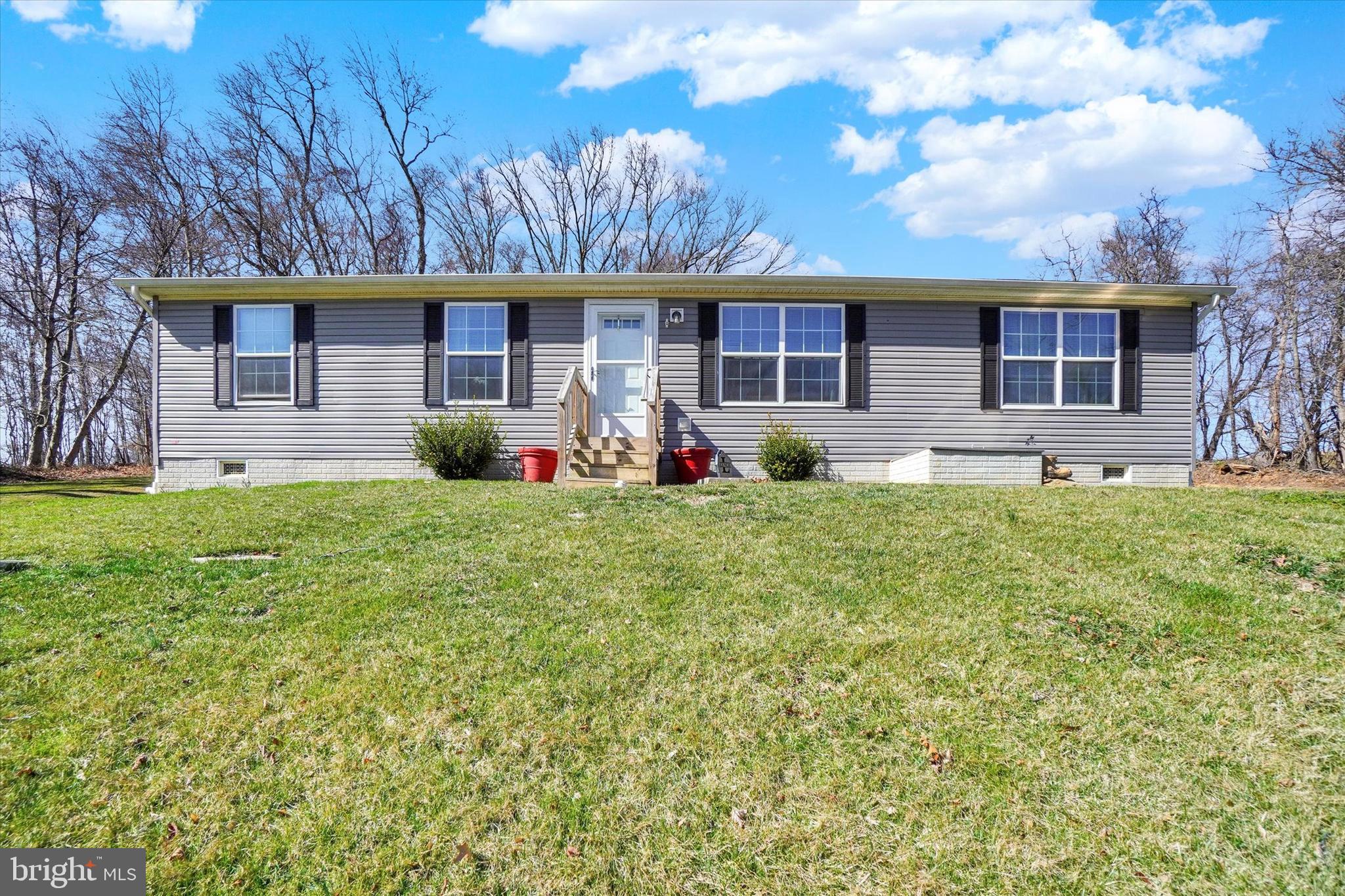 Great rural location and one level living in Red Lion school district.  Enjoy your privacy with this hilltop setting on an over 3/4 acre lot.  This 2020 model double wide manufactured home offers over 1300 square feet with 3 bedrooms, 2 full bathrooms.  The primary bedroom features a large walk-in closet and a full bath ensuite, both located on one side of the home with an additional 2 bedrooms and full bathroom on the opposite end.  An open concept floor plan for the kitchen, dining and living rooms is the focal point in the center of the home. The concrete foundation has easy access to a crawl space suitable for storage.  A 25x33 Morton Building offers opportunity for covered parking with a single, overhead door with automatic opener. There is abudant space for a workshop. Several windows allow natural daylight and a woodstove will keep you warm in the winter months while working on your projects.  Hurry! You don't want to miss this opportunity to enjoy country living!