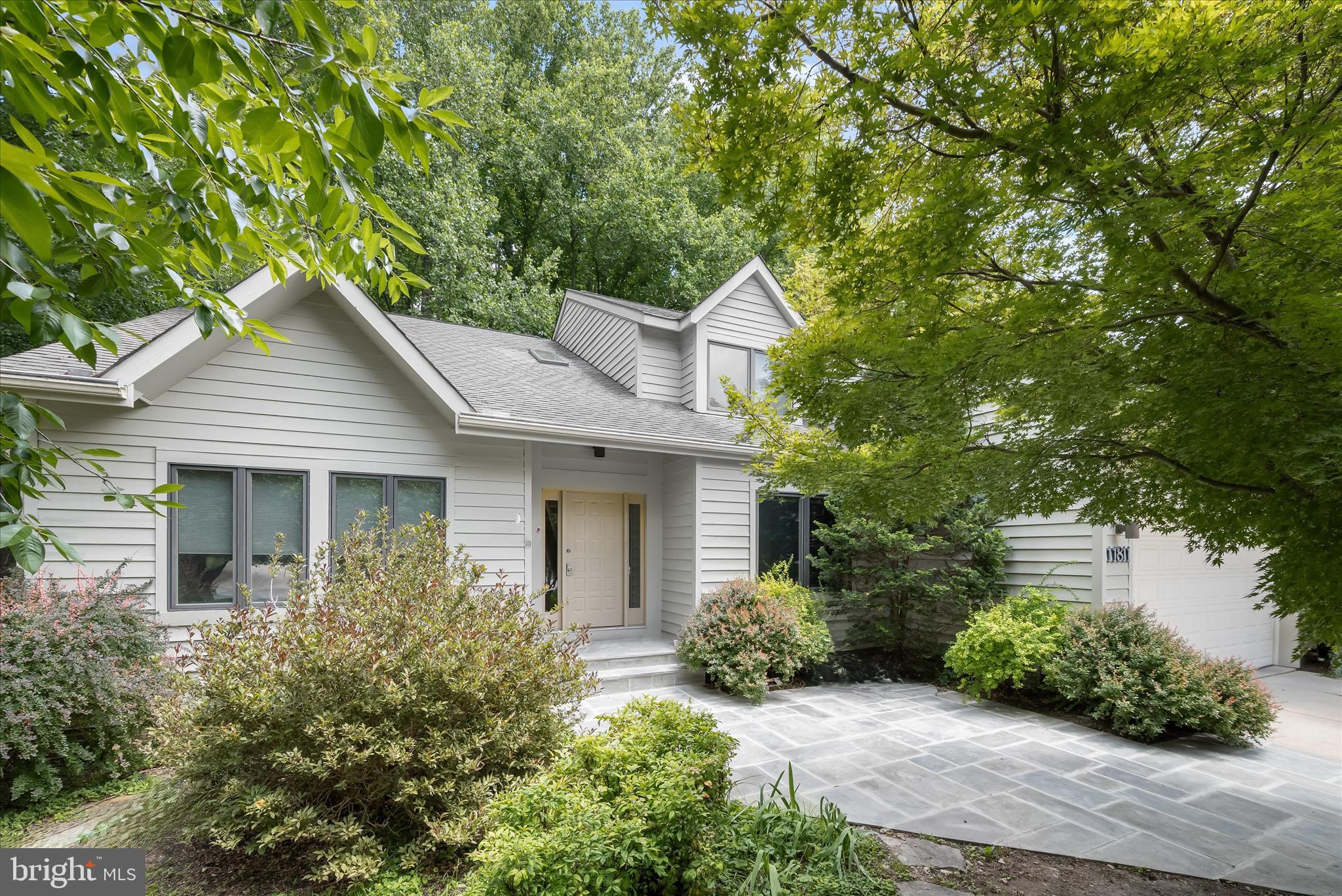 Tucked away on a quiet cul-de-sac in Columbia's highly sought-after Village of Hickory Ridge, 11811 Far Edge Path is a custom residence set on a beautifully landscaped lot surrounded by mature trees. With over 4,500 square feet of living space, the property seamlessly blends classic architecture with modern comfort and craftsmanship.

The bright foyer features hardwood flooring and large skylight, opening up to spacious living areas filled with natural light. Formal living and dining rooms provide dedicated spaces for entertaining, while a versatile front study serves as an ideal home office or library. The expansive family room centers around a cozy gas fireplace with custom wood built-ins, offering direct access to both the kitchen and dining deck.

The kitchen is fully equipped for everyday meals and large gatherings alike, featuring wood cabinetry, a pantry, granite countertops, a center island, and stainless steel appliances, including double wall ovens and a gas cooktop. A sunny breakfast area overlooks the backyard, while convenient deck access makes outdoor dining easy.
 
A major highlight of the home is the custom sunroom addition, which earned a Silver Merit Award of Excellence from the Remodelors Council. This room features soaring vaulted ceilings, rich hardwood flooring, walls of windows, and panoramic views of the surrounding woods. Equipped with a custom wet bar, sink, and beverage refrigerator, this space flows directly out to the expansive dining deck for easy indoor-outdoor entertaining. A separate laundry room and powder room complete the main level.

Upstairs, the spacious primary suite includes a walk-in closet and a private bath with a soaking tub, separate shower, and dual vanity. Two additional bedrooms, a versatile loft with built-in cabinetry, and a full hall bath provide plenty of accommodations for family and guests.

The finished walkout lower level adds incredible flexibility to the floor plan, featuring a large recreation room perfect for movie nights, hobbies, or a home gym. A full en-suite bedroom offer an ideal setup for guests or multigenerational living, alongside ample storage and workshop space.

Outside, the spacious patio overlooks the wooded backdrop, offering a tranquil retreat for outdoor enjoyment. Connecting stairs lead to the upper deck, creating multiple levels of outdoor living space. A two-car attached front-load garage provides convenient everyday entry, parking, and additional storage space.

Located in one of Columbia's premier communities, this home offers quick access to local walking trails, parks, shopping, dining, and major commuter routes. With its award-winning design, generous layout, and private setting, this property is a rare opportunity in Hickory Ridge.