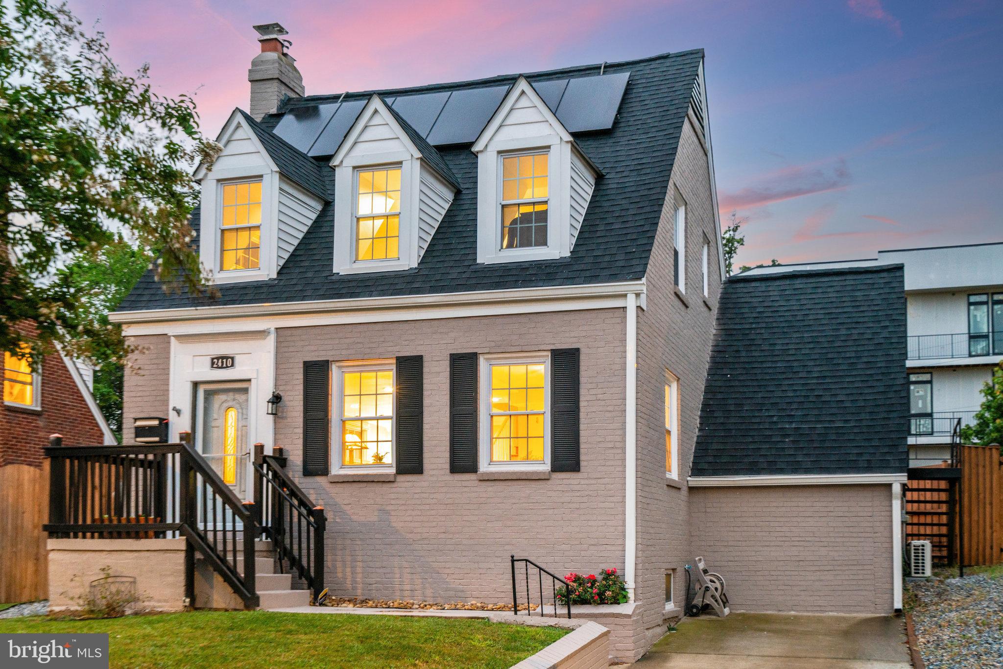 Welcome to 2410 21st Pl NE, a charming Cape Cod situated on a private corner lot in the heart of Northeast DC. Thoughtfully updated and exceptionally versatile, this home combines timeless character, modern conveniences, and flexible living spaces designed to adapt to a variety of lifestyles.

Sun-filled east-west exposures bathe the home in natural light throughout the day, highlighting hardwood floors on the main and upper levels, updated lighting, and a welcoming living room anchored by a wood-burning fireplace with a new liner and stack installed in 2019. The beautifully updated kitchen features quartz countertops, custom cabinetry, and modern appliances, opening seamlessly to a spacious dining area ideal for everyday living, entertaining, and hosting guests.

A practical mudroom and laundry area provide convenient access to both the backyard and a private guest suite with ensuite bath. This flexible space has served as a comfortable guest retreat and a successful short-term rental, offering excellent potential for visitors, workspace, hobbies, or supplemental income.

The upper level features two generously sized bedrooms filled with natural light and a fully renovated bathroom with a soaking tub and modern finishes. The finished lower level serves as a spacious primary retreat, complete with a spa-inspired bathroom, two large closets, and a cozy sitting area.

Recent upgrades include spray foam insulation (2022) and solar panels (2020), helping improve energy efficiency while generating nearly $4,000 annually through Solar Renewable Energy Credits (SRECs).

Outside, enjoy a private, fully fenced backyard designed for both relaxation and entertaining. Featuring over 400 square feet of paver patio outdoor living space, gazebo, raised garden beds, and storage shed, the west-facing yard provides the perfect setting for outdoor dining, gardening, gathering with friends, enjoying spectacular sunsets, or spending time with pets.

Additional storage is available above the guest suite and is easily accessed via the exterior staircase on the north side of the home. Off-street parking for two or more vehicles adds a rare level of convenience.

Freshly painted inside and out in 2024, this move-in-ready home is located just three blocks from Langdon Park and minutes from Rhode Island Metro, Rhode Island Row, Dakota Crossing, Costco, Lowe's, Home Depot, and Downtown DC. Offering the perfect combination of charm, flexibility, efficiency, and convenience, this is a home that truly stands apart.

Schedule your private tour today.