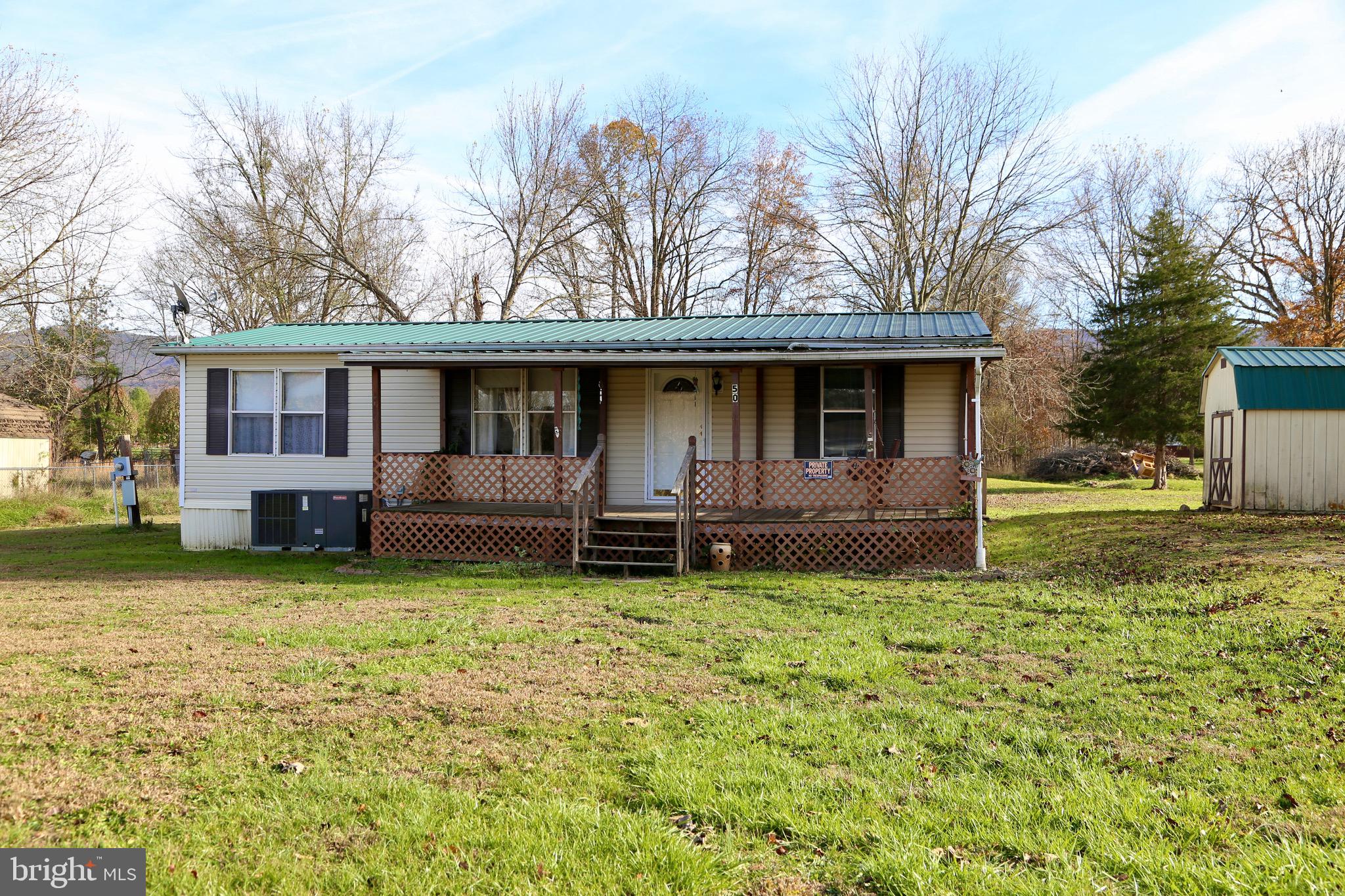 Welcome to the perfect starter home or downsizing opportunity! This cozy 3-bedroom, 2-bathroom home sits on a peaceful 0.7-acre lot on a quiet street in the charming town of Wardensville. Inside, the inviting family room flows seamlessly into an eat-in kitchen, complete with plenty of storage. The primary bedroom off the living room includes a private bath and a walk-in closet, while two additional bedrooms and another bathroom are just down the hall for added convenience.

You'll love the sunny mudroom—ideal for houseplants—which opens onto an enclosed porch where you can relax and enjoy the quiet mountain evenings. Outside, the spacious yard offers ample room to run and play, plus two outbuildings with plenty of storage for tools or toys.

This home is move-in ready, with updates like a durable metal roof, central heating and cooling, a new washer and dryer, and an upgraded hot water heater. And the best part? You’re just two minutes from local restaurants, boutique shops, and farmers' markets, yet tucked just outside of town limits.

Don’t miss your chance to tour this charming home in Wardensville—schedule your visit today!
*** We are requesting any offers be submitted by 6pm Monday 11/18/24. ***