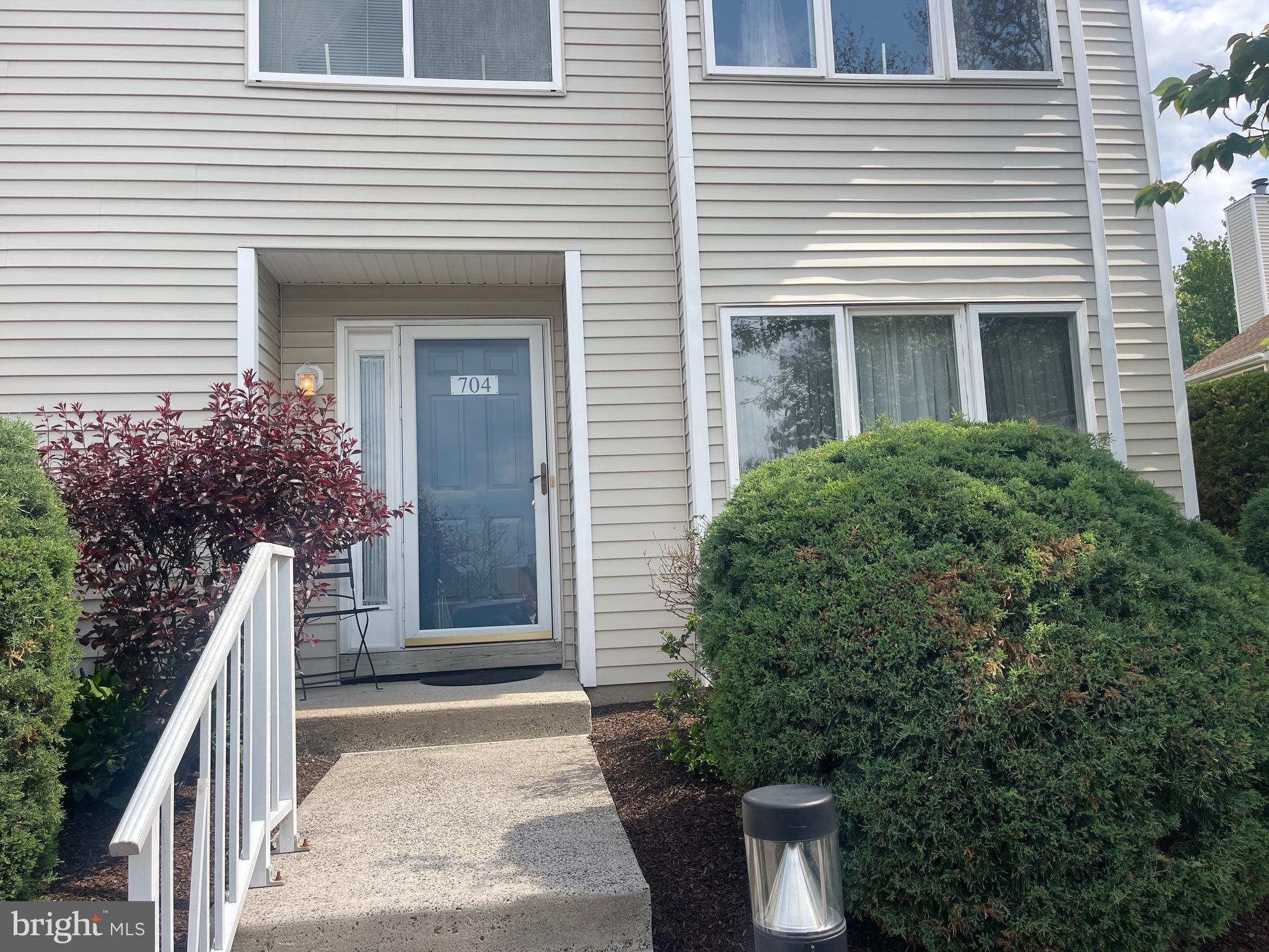 Welcome home to this spacious and well-maintained end-unit townhome, ideally situated in one of the most desirable and convenient locations within Montgomery Place. Just steps from the community pool and clubhouse and within walking distance to shopping and everyday conveniences. Upon entering, beautiful wood floors guide you into the inviting living room, highlighted by a handsome fireplace with a marble surround and classic wood mantel — an ideal focal point for both relaxing and entertaining. The dining area features sliding glass doors that open to the patio allowing the natural light to fill the room and creating an easy flow for indoor-outdoor living. Adjacent to the dining space is a charming eat-in kitchen, while the nearby laundry room offers added convenience along with ample space for additional storage.  The second level offers a welcoming landing that leads to a spacious primary suite with a full bath, two additional generously sized bedrooms, and a hall bath. Combining space, location, and value, this home presents a wonderful opportunity to enjoy low-maintenance living in a sought-after community.
