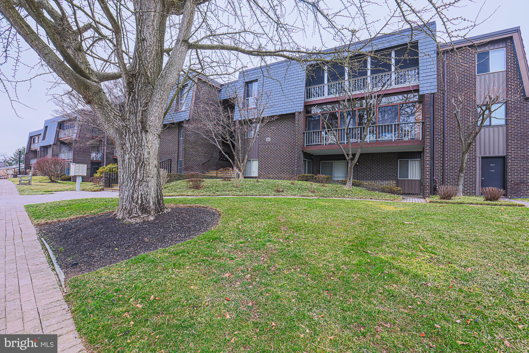 **SUBSTANTIAL PRICE DROP!!** Unique first floor unit offers option for 'no stairs entry' via sidewalk from parking area directly to ground level covered porch with two sliding doors.  Bathed in natural light, this modern, open concept  marries defined living space with seamless flow.  Features include brand new furnace, wood parquet flooring, 22 foot covered porch for outside living, 13 x 6 walk-in closet complete with built-ins, eat in kitchen, laundry, alarm system.  Condo fee includes  water, sewer, gas heat,  trash pick up outside your door,  snow removal, storage bin.  Community amenities feature beautifully landscaped grounds, gorgeous pool, clubhouse, security gate, walkways, street lighting, abundant parking.   Serenity abounds in this ideal location and offers easy access to local amenities and commuter routes.  This building has a new roof with a $79,00 assessment, included in monthly condo fee through December 2025.  Service/comfort animals only.  Home sold AS IS.  Some photos virtually staged with furnishings to show versatility of space.