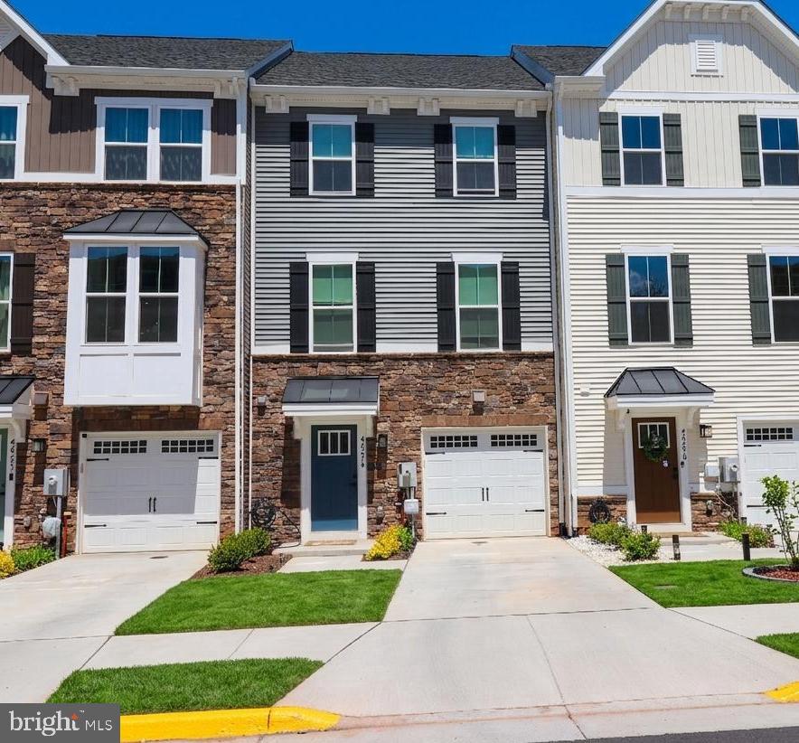 Beautiful only ONE year old home (2025 new construction) with approximately 2,340 square feet has four finished levels, the home includes four bedrooms, three full bathrooms, two half bathrooms, and a one-car attached garage. The main level is open with gourmet kitchen, stainless steel appliances large island and a spacious living room. Upstairs is the master suite with walk in closet and private full bathroom. Two other bedrooms and another full bathroom. Top floor has fourth bedroom, full bathroom and rooftop terrace with amazing views. Walking distance to Costco, target, Harris Teeter, and plenty of diverse restaurants. Community includes a newly constructed family oriented pool area, playgrounds basketball and tennis courts. From the community entrance you can see on one side all of Loudoun, and on the other side all the way to Reston town center. Truly living up to its name of “Loudoun View”