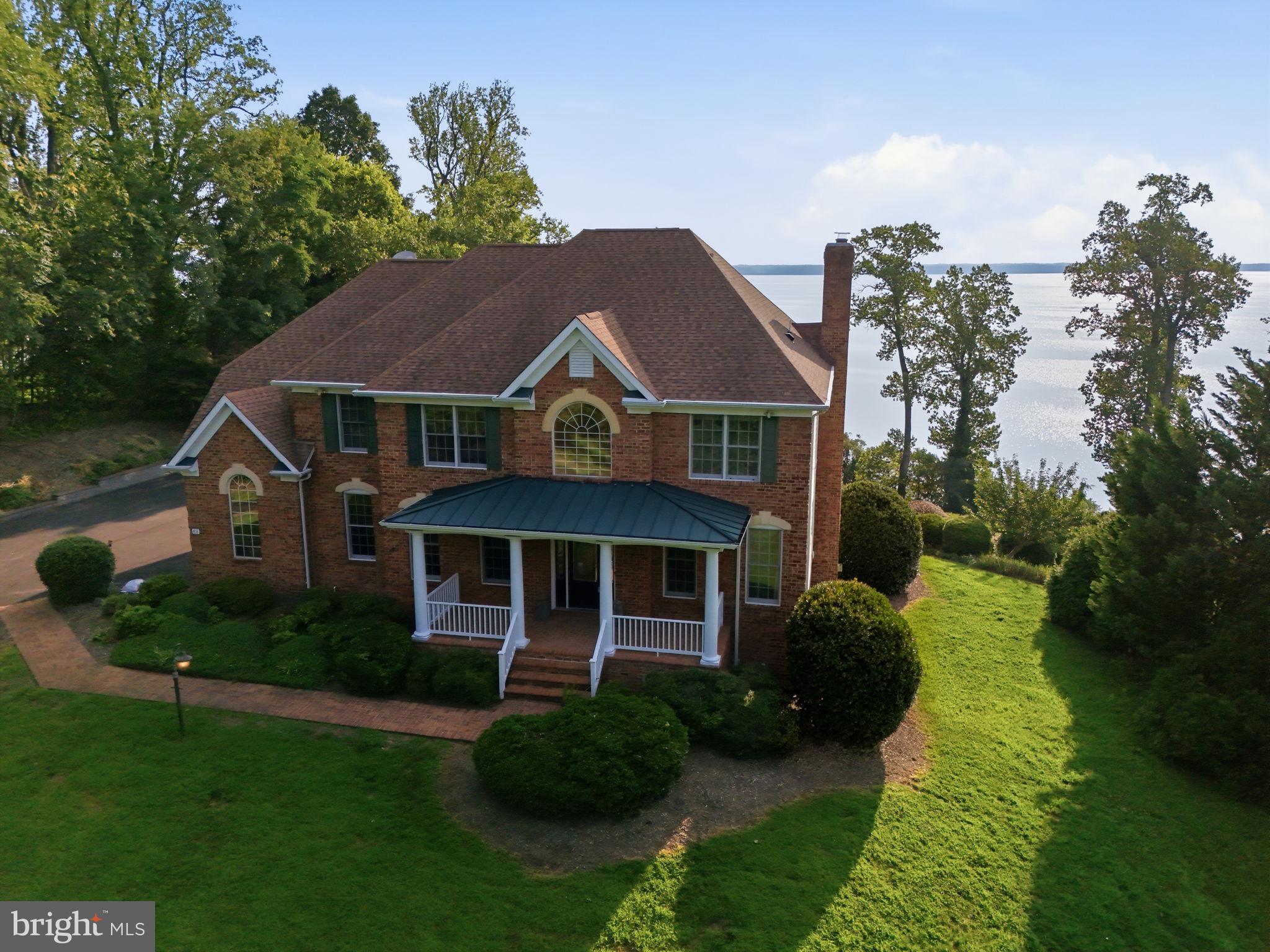 Absolutely stunning brick front colonial on over 2.75 acres with sweeping Potomac River views stretching more than 15 miles and a private dock with boat lift. Over 4,300 finished square feet, 4 bedrooms plus a bonus room with adjacent full bath that could serve as a fifth bedroom,3 and a half baths otherwise and a dramatic2 story foyer and family room. Kitchen with granite counters, ceramic backsplash, newer stainless appliances, walk-in pantry, and access to a large screened-in sunroom and deck for year-round views. Main level office with built-ins, walk-out rec room with built-ins and wet bar, hardwood floors throughout most of the home, one gas fireplace plus one wood-burning fireplace, built-in speakers throughout, walk-in closets, Jacuzzi tub, upstairs laundry, 3 car side load garage, extra basement storage, whole house Generac generator, water softener, and brick walkway. Spectacular river views from most bedrooms. Approximately2 miles to the Brook VRE and about 15 miles to historic Fredericksburg. Verizon high-speed internet available. A rare waterfront opportunity offering luxury, privacy, convenience and unforgettable views.