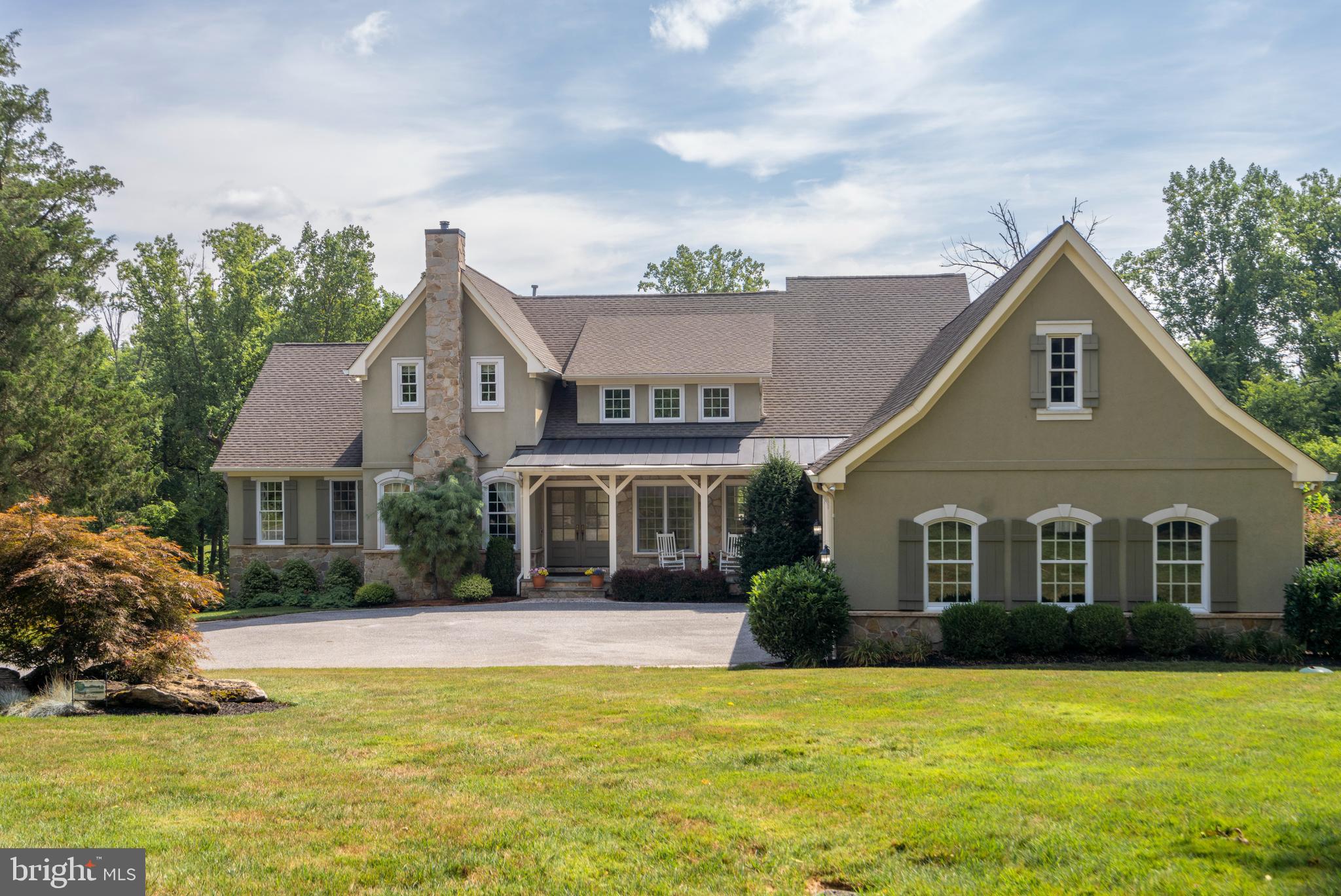 Welcome to 1307 Dulaney Valley Rd, a stunning French Country-inspired residence, custom-built in 2007 for its current owners. This home epitomizes casual elegance with its thoughtfully designed open floor plan, offering approximately 6,000 square feet of luxurious living space. Boasting 10-foot ceilings, intricate millwork, graceful archways, hardwood floors, and top-of-the-line appliances, this residence promises an exceptional living experience.
Set on 1.9 meticulously landscaped acres in the sought-after Hampton community, this property ensures privacy with its secluded pipeline driveway, while remaining conveniently close to the beltway.
The charming curb appeal is immediately evident as you approach the home via a circular driveway. A welcoming covered porch leads you through double doors into a spacious foyer, which opens to an elegant dining room and a handsome library with a mantled gas fireplace, accessible through pocket doors. The heart of the home, the expansive family room, is bathed in natural light and features a stone fireplace flanked by large windows with transoms. The gourmet kitchen, a chef’s delight, includes a large island, Wolf cooktop, beamed ceilings, and a sunlit breakfast area. Enjoy your morning coffee in the cozy screened porch overlooking the beautifully landscaped, fully fenced rear yard.
The main floor also includes a luxurious primary bedroom suite with a spa-like bath featuring a soaking tub and a spacious, dedicated dressing room. Additional conveniences on this level include a powder room and a dedicated laundry room.
Upstairs, you’ll find an optional second primary suite with a private bath, a loft area, and two additional bedrooms that share a hall bath. The lower level is designed for relaxation and entertainment, featuring a rec room with a full wet bar, an exercise room, and a fourth full bath. There’s also a workspace and a utility room offering ample storage space.  Available for showings starting at the Open House, Wednesday, August 7th from 1-3pm