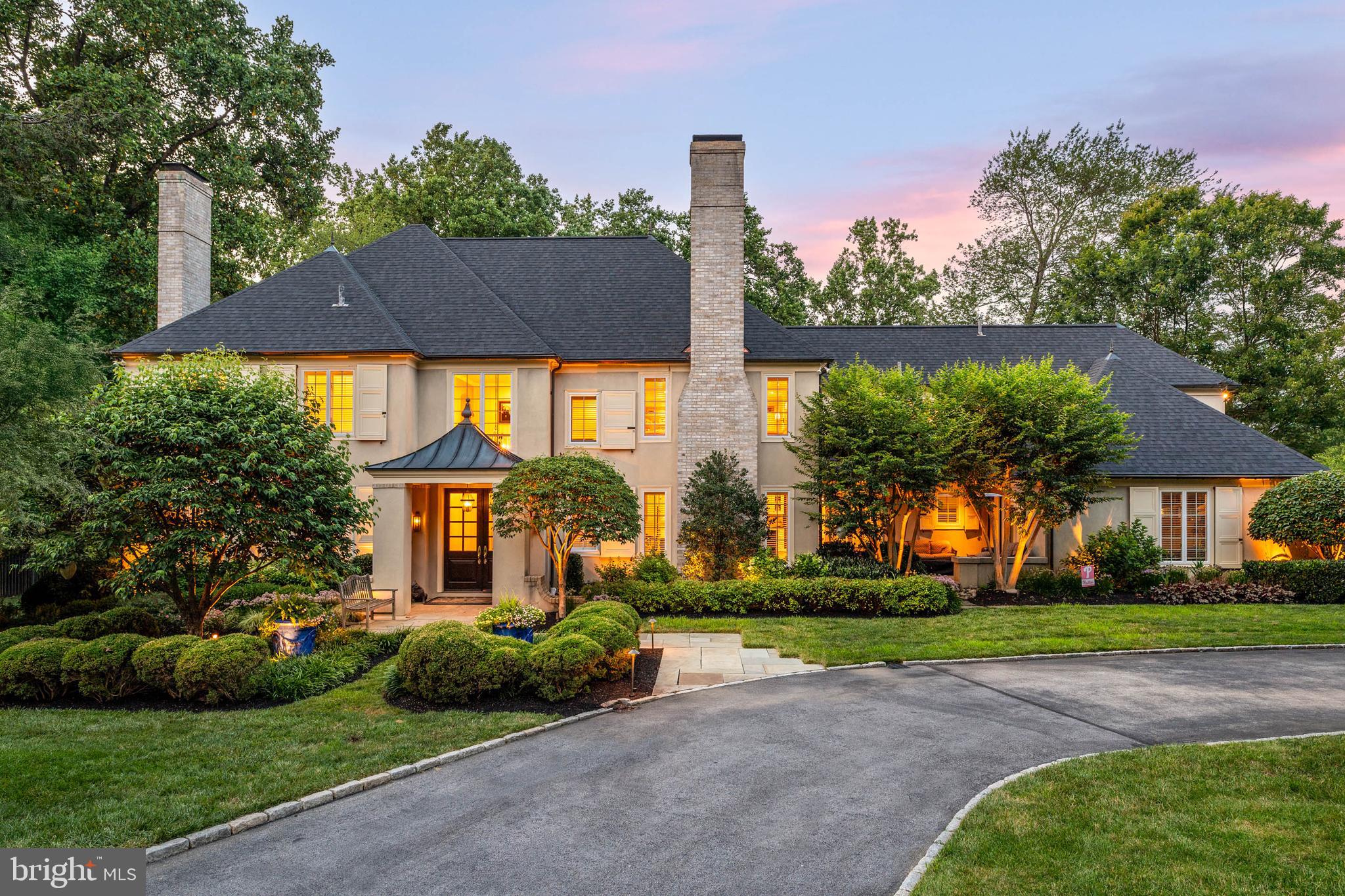 Welcome to 936 Roscommon Road, a stunning Colonial-style home in historic Bryn Mawr, offering over 5,000 sq/ft of luxurious living space with 5 bedrooms, 4 full baths, and 3 half baths. This private estate, nestled on over an acre of lush grounds, makes a grand first impression with its horseshoe drive and manicured landscaping. Step inside a light-filled 2-story foyer that opens to the formal living room, featuring a gas fireplace, coffered ceiling, and hardwood floors that extend throughout the main level. The adjoining office provides a quiet and sophisticated workspace enhanced by a coffered ceiling and wainscoting, as well as access to the slate patio with hot tub — a perfect place to relax after a long day. The formal dining room, complete with picture frame molding and chandelier is a sophisticated space to dine, and the adjoining Butlers Pantry makes entertaining a breeze. Across the foyer is a cozy sitting area with a gas fireplace and sliding glass doors leading to another slate patio, perfect for enjoying your morning cup of coffee. The adjoining gourmet kitchen is a chef's dream, boasting raised panel cabinetry with crown molding, granite countertops, tile backsplash, a butler's pantry, built-in desk, an oversized island with seating, and high-end appliances, including a paneled refrigerator, double wall ovens, and a six-burner gas range. The bright and sunny dining area, with French doors leading to the deck, flows seamlessly into the adjoining family room featuring a vaulted ceiling, a gas fireplace with built-ins, an oversized window with bench seating, as well as another set of French doors opening to the back deck, creating a perfect gathering space for family and friends. A convenient laundry room and two half baths complete this level. Upstairs, the open landing leads to the spacious primary suite, a luxurious retreat with a wood-burning fireplace, built-in shelving with bench seating, and a spa-like bath. The primary bath indulges with a dual vanity, make-up vanity, glass-enclosed shower, and a separate jetted tub. Three additional bedrooms with recessed lighting, ceiling fans, ample closet space, and two full baths, including a "Jack and Jill" with skylight, and a full hall bath with glass-enclosed shower/tub combo & dual vanity, complete the second level. The fifth bedroom is a cheery suite, above the 2-bay garage, with its own full bath, and is perfect for a guest, au pair, or in-law suite. The finished basement provides additional flexible living space, including a media room, exercise room, half bath, and ample storage space. Out back, discover your own private oasis. The expansive outdoor space features a wooden deck and slate patio, a heated saltwater in-ground pool with hot tub, and plenty of space to lounge and entertain in a serene setting. Located on the distinguished Main Line, this home is within the award-winning Lower Merion School District. Enjoy easy access to Conshohocken State Road and I-76, with major shopping, restaurants, golf courses, and all that Bryn Mawr has to offer. Don't miss this incredible opportunity to live in this truly spectacular home!