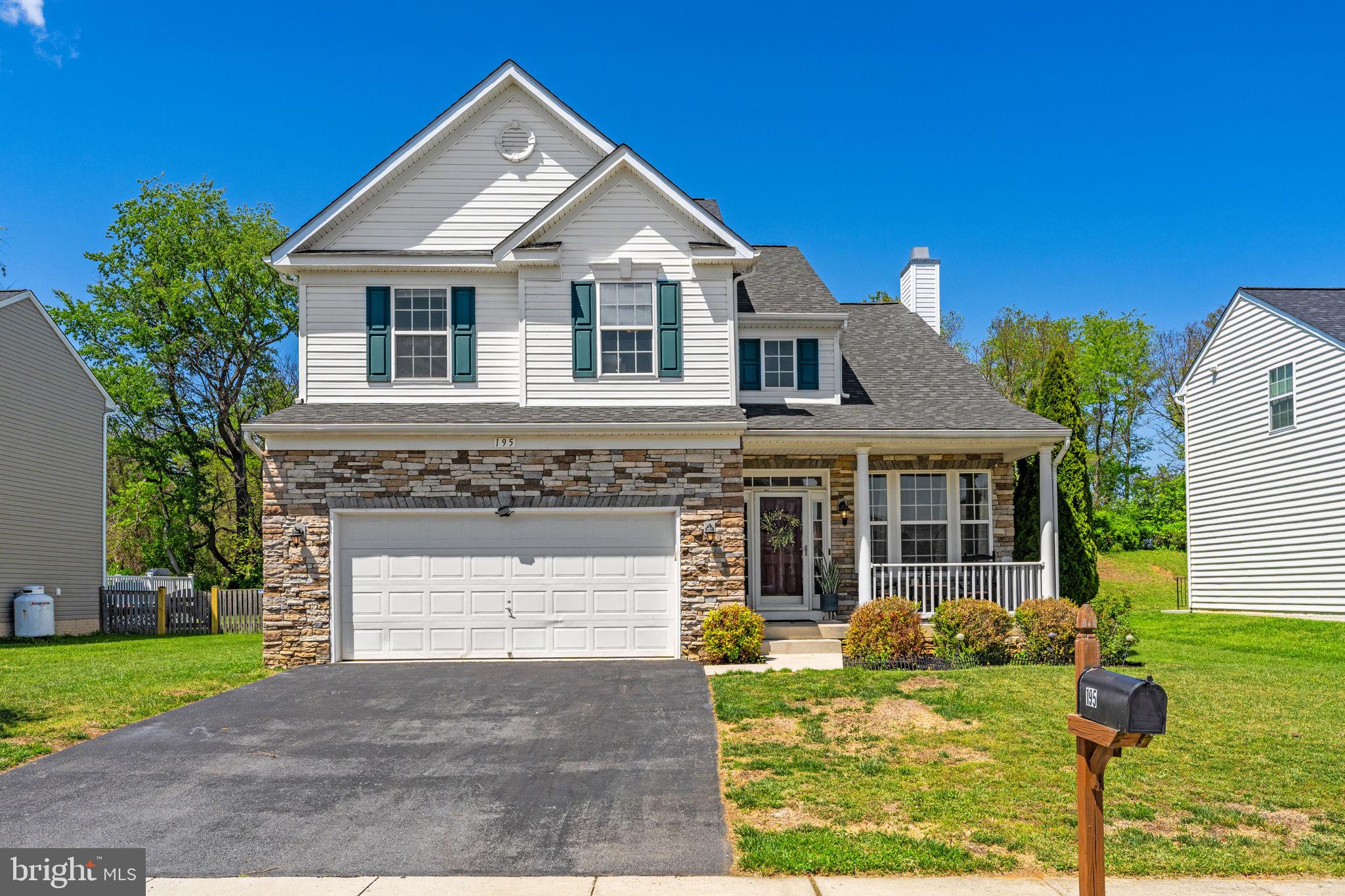 Enjoy bright, comfortable living in this spacious Charles Town colonial with a fenced backyard, large wood deck, and a tree-lined backdrop. Set on .24 acres with a welcoming front porch, stone accents, and vinyl siding, this 4-bedroom, 3.5-bath home offers room to gather, relax, work, and play.

Inside, high ceilings, hardwood floors, and natural light give the main level an open, airy feel. The living room features a cozy wood-burning fireplace, while the spacious kitchen offers granite countertops, a large island, breakfast bar, black appliances, dishwasher, disposal, and two generous pantries. The sunny breakfast room opens to the deck and backyard, creating an easy flow for outdoor dining, entertaining, gardening, or quiet evenings at home.

Upstairs, the large primary suite feels like a private retreat with a cathedral ceiling, ceiling fan, walk-in closet, and attached bath with soaking tub, double vanity, and walk-in shower. Three additional bedrooms and a full hall bath complete the upper level.

The fully finished basement adds flexible living space with a carpeted recreation room, full bath, and multi-purpose room, ideal for movie nights, hobbies, guests, or a home office. Additional highlights include a two-car garage, main-level laundry, smart thermostat, active radon system, fresh paint approximately one year ago, new roof in 2019, and newer disposal.

Close to Route 9, the Virginia line, shopping, schools, restaurants, and Hollywood Casino, this home blends everyday convenience with space to truly settle in.