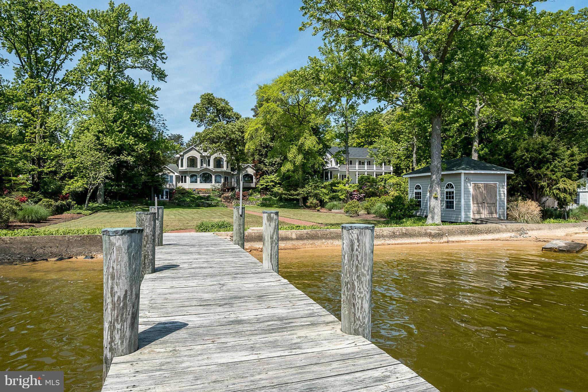 IMAGINE WAKING UP TO THIS! Incredible waterfront home w/breathtaking views & 5 large bedrooms on almost 1.5 acres! Take advantage of the water views from the large gorgeous windows. Very spacious w/living & family rooms, offices, gourmet eat-in kitchen, plus a LL kitchenette. Two 2-car garages. Deck, patio, boat house & pier w/boat slips. Serene surroundings, perfect for entertaining & relaxing.