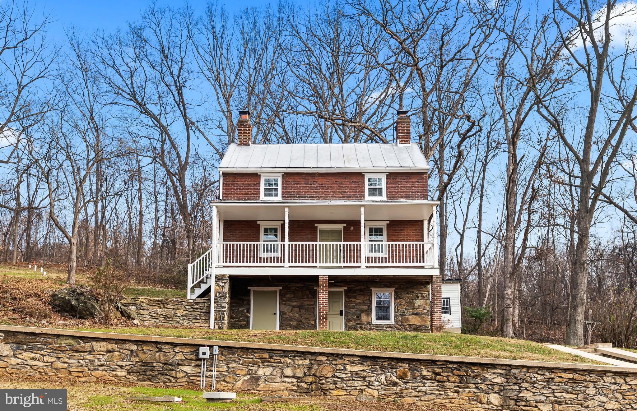 Completely remodeled all brick farmhouse on 3.5 acres with a pond.  The property also features a spring house, stone retaining walls and a detached building.  Sit on your front porch overlooking you're large front yard with a pond in sought after Myersville.  The home also has all new electric, plumbing, HVAC, well and septic system.  The inside is tastefully remodeled with a modern farmhouse style which includes 2 brick fireplaces, a completely new kitchen, 3 new bathrooms, new flooring throughout, new drywall and paint throughout.  Enjoy the privacy of 3.5 acres with the character of a farmhouse all with the modern conveniences of a new home.  Must see!!