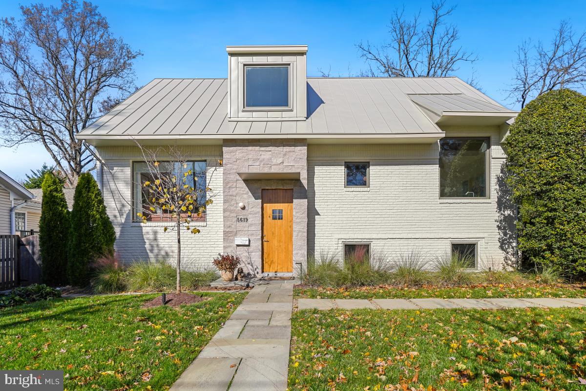 The architecture at 5619 Oakmont is both stunning and thoughtfully designed. Originally built in 1961, the home was completely reimagined and meticulously renovated in 2023. As you approach at dusk, the intentional landscape lighting beautifully highlights the mature trees and sets the tone for what awaits inside.  Step into the two-story foyer where natural light and open space create an immediate sense of welcome. The main level features a dining area and a chef’s kitchen that opens to a remarkable great room with skylights and expansive views of the outdoors. This level also includes a powder room, a bedroom with an ensuite bath, and a dedicated home office.  Upstairs, the primary suite offers a spacious walk-in closet and a spa-inspired bath. An additional bedroom with an ensuite bath completes this level.
The lower level offers a cozy family room with a wood-burning fireplace, an additional bedroom, a full bath, a bonus room, and a laundry room with generous storage.
Outside, the fully fenced backyard is your private oasis, featuring thoughtfully designed gardens and a Deco-style deck perfect for outdoor living. The home also includes a Tesla charger for added convenience.
Ideally located steps away from Ayrlawn Park, plus easy access to schools, shopping, and restaurants, this exceptional home is not to be missed.