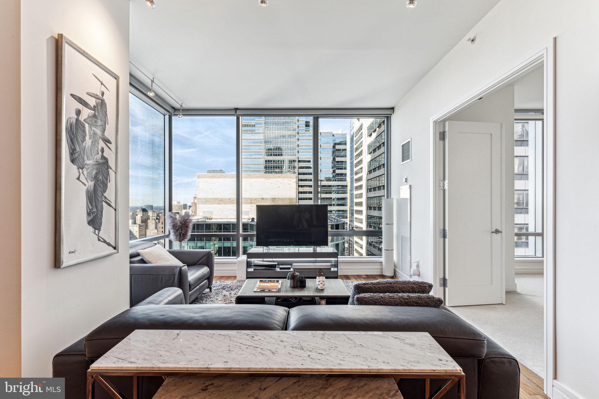 FIVE-STAR LUXURY LIVING AT THE RESIDENCES AT THE RITZ CARLTON – Soaring 34 stories above the city, this impeccable one bedroom, one and a half bath residence offers breathtaking panoramic views of the city skyline. The living and dining areas feature expansive ceiling heights, gleaming hardwood floors, and a wall of windows flooding the interior with light. The chef's kitchen boasts granite countertops, DORNBRACHT fixtures, and top-of-the-line VIKING, SUB-ZERO & MIELE appliances. The generously proportioned bedroom offers double door closets with organizers. The marble spa-like bathroom showcases double sinks with storage vanities, an oversized walk-in shower with a frameless glass door, and a large BAIN ULTRA soaking tub. Association fees include a 24/7 concierge, chauffeur-driven sedan, state-of-the-art fitness center, pool with a hot tub, and a residents' lounge with a media room and outdoor terrace. Perfectly situated in the Rittenhouse and Avenue of the Arts area, this deluxe pet-friendly residence is steps away from fine dining, unique shopping, world-renowned cultural destinations, and vibrant nightlife.