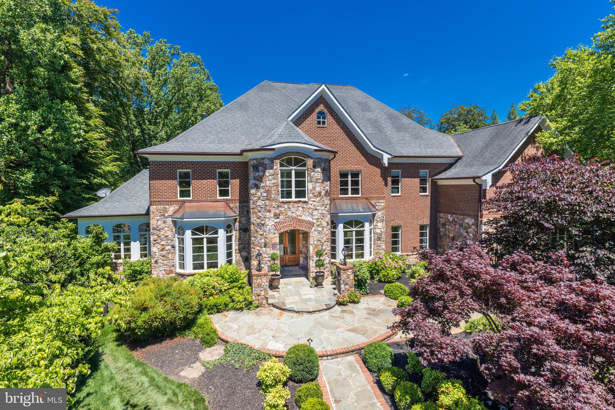 9,350 SF!  This stunning estate home is handsomely sited on a lushly landscaped acre at the end of a cul de sac.  One of the few homes built in The Reserve by custom builder Adrian Edwards . The inspiring beauty starts at the curb, carries through the grand floor plan and into tranquil outdoor living spaces. An entertainer’s delight, one can easily host over 150 people for both formal and informal gatherings.  The center hall is anchored by the compass rose marble inlay, from which the home's formal rooms radiate. Each room is finely curated with crown and picture molding . The main level is designed for entertaining with spacious formal living and dining rooms.  Adjacent to the living room is a light-filled and airy conservatory, perfect for listening or playing music or just escaping to nature. Through the foyer towards the back of the house is a private mahogany library/executive office perfect for running your business or cozying up with your favorite book. The extensive built-in shelves can house your book collection. The main level continues with a family room complete with soaring ceilings, stone fireplace, views of the woods and opens to an oversized, gourmet kitchen. The open kitchen is connected to the screened in porch, a tranquil spot any time of day.  Enjoy the soothing sounds of nature and the new fountain feature.  The gourmet kitchen is well equipped with the stainless-steel double oven, two dishwashers, multiple meal prep stations and a pantry. The large center island has seating and ample extra storage.  There is also a work-station in the kitchen to use as your command central and a second staircase leading the upper level for quick access. Off of the hallway is a main-level ensuite bedroom, laundry room, pantry, mud room and access to the three-car garage. The upper level features 5 generous sized, en suite bedrooms with walk-in closets. The master suite is elevated from the rest of the bedrooms, providing privacy and sweeping natural views. It is a lovely retreat, complete with a sitting room/private office, double-sided fireplace and private storage. The luxurious master bathroom has separate vanities, shower and bath.  The walk-in closet is a masterpiece!  Further down the hall there is a bonus built in study area, equipped for two with built-in desks, bookshelves and storage perfect for multiple students. Also here is a 2nd laundry room with a brand-new sink and washer (2019)/dryer (2021).  At the end of the hallway is the pinnacle of the second floor: an expansive natural light drenched artist studio, which could also be used as a private office, playroom or au pair suite.   Entertainment options abound in the lower level, boasting 10.5ft ceilings with a recreation area perfect for media, hosting or playing ping pong and pool. Walk-out through French doors to the patio, enjoy the fire pit and bubbling water feature in the backyard. The 7th bedroom is currently being used as a pool room and bar, but has previously served as bedroom with the adjoining bathroom and closet. This level also features approximately 1000 sq ft of essential storage. The home is surrounded by the privacy of nature and boasts exquisite landscaping and stonework. This home exterior is completely maintenance free. Weather Shield windows and doors.  All the trim is Timbertek AzEK which requires no maintenance.  ***ADDITIONAL CONVEYANCES:  Pool table   Tesla/electric charger   Green hutch in kitchen (if desired)