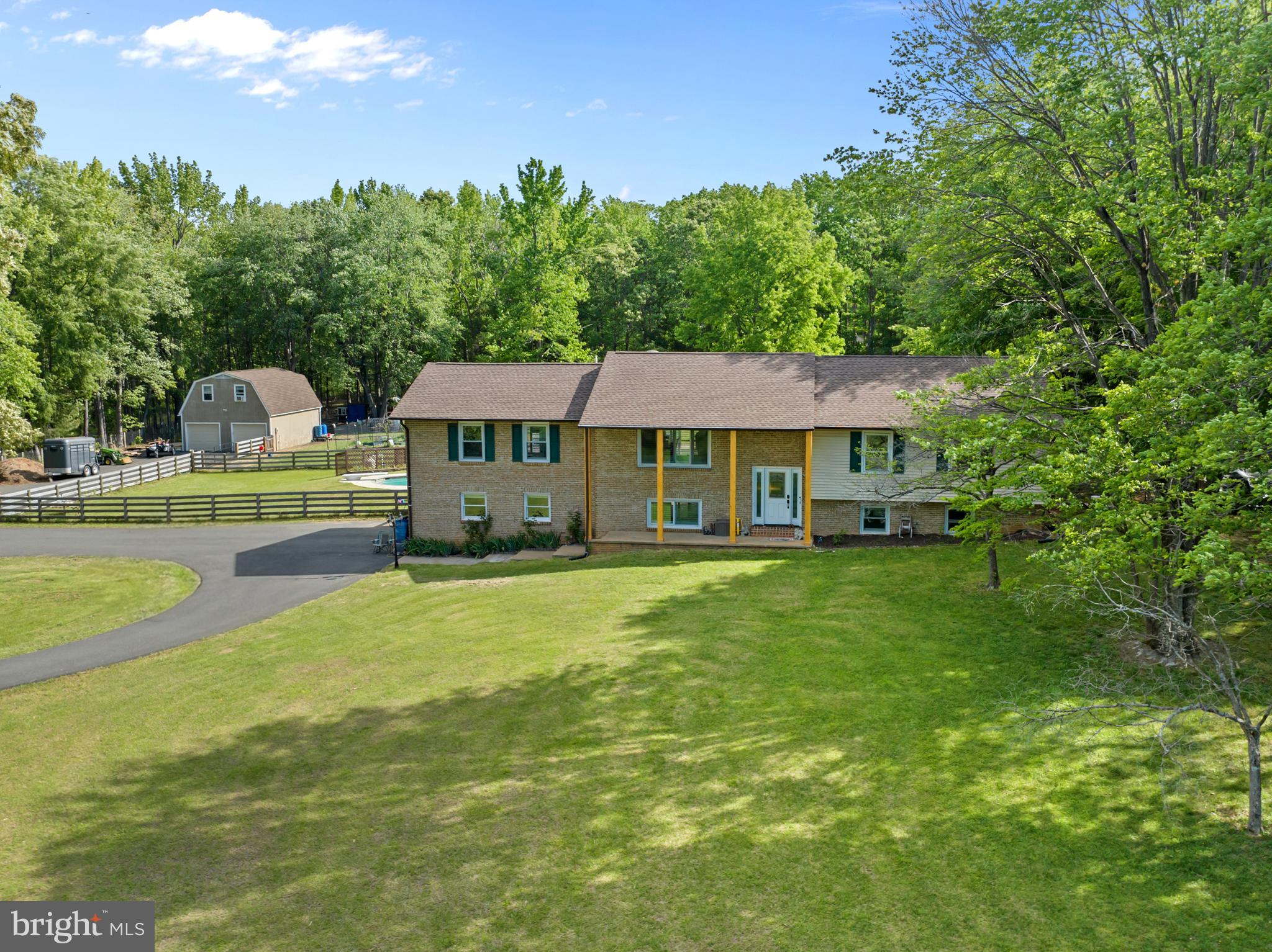Rare opportunity on the DC side of Warrenton! Nestled on 3.37 tranquil acres in the highly sought-after Vint Hill/New Baltimore area, this exceptional property offers the perfect blend of peaceful country living and commuter convenience, less than 10 minutes to Gainesville and Rt. 66. With rural agricultural zoning, the property invites endless possibilities including gardening, hobby farming, bee hives, chickens, and other farm animals. This spacious 5 bedroom, 3 bathroom home is designed for both comfortable everyday living and entertaining. The heart of the home is the stunning open kitchen, generous counter space, and plenty of room to gather. The expansive lower level includes a private in-law suite, offering flexible living space ideal for extended family, guests, or multi-generational living. Step outside to enjoy your own private retreat with an in ground pool, expansive deck, fenced yard, and beautiful open acreage. Additional highlights include an oversized side load two car attached garage, plus a large detached garage workshop with loft space ideal for hobbies, storage, equipment, or a future studio. A rare find offering privacy, space, versatility, and an unbeatable location with high speed internet both Fios and Xfinity.