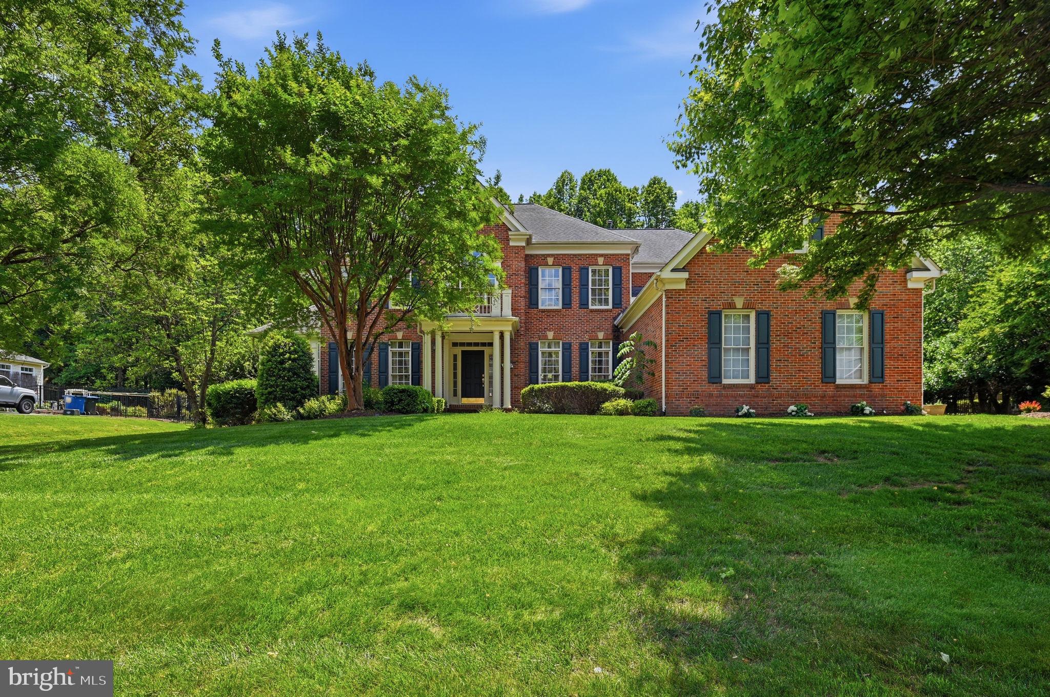 Immaculately built and beautifully maintained, this exceptional home in Caris Glenne offers an elegant blend of space, comfort, and thoughtful updates set on a private, landscaped lot designed for everyday living and memorable entertaining.

Step inside to a two-story foyer and an open, contemporary main level highlighted by hardwood floors. A bright sunroom with vaulted ceilings, ceiling fan, and abundant windows is perfect for plant lovers or a peaceful reading retreat. A private den/office with French doors makes working from home effortless, and a convenient powder room completes the main level.

The inviting t.v. room features a vaulted ceiling, plush carpet, and a gas fireplace, with windows and direct access to the deck for seamless indoor/outdoor living.

At the heart of the home is the updated kitchen. Well-appointed with granite countertops, a center island, double ovens, a dedicated microwave nook, and an oversized walk-in pantry with extensive shelving. A butler’s pantry adds additional storage and serving space. Enjoy backyard views from the kitchen window with automatic blinds, plus convenient access to the garage and laundry area. The eat-in space is accented by a statement chandelier, and the sun-filled breakfast area (Florida room-style) opens to the deck and backyard.

Formal spaces include a separate living room with wainscoting and chair rail, and a dining room with chandelier and decorative ceiling medallions, ideal for entertaining.

The three-car garage offers abundant storage and includes an EV charger (extra refrigerator in garage approx. 3 years old).

Upstairs, the luxurious primary suite impresses with a vaulted/coffered ceiling and ceiling fan, a private sitting room with gas fireplace, and a coffee station/wet bar with sink and mini-fridge area. The spa-inspired primary bath includes a soaking tub, walk-in shower, and two walk-in closets. Three additional bedrooms provide excellent closet space, one of the bedoroms with a private en-suite, plus a beautifully finished hall bath with dual vanities, honeycomb tile flooring, and a walk-in shower.

The lower level is an entertainer’s dream with a private media room (projector approx. 3 years old) and speakers, a recreation space/art room with built-ins, workout area or additional living space, guest/bonus room, full bath, and a mini bar with a large wine fridge. A private exterior entrance and abundant storage add convenience and flexibility.

Outside, enjoy a fully fenced backyard with a composite bin, mature trees, and a thoughtfully designed setting for relaxing or hosting: grill on the deck, unwind on the paver patio with pergola, gather around the fire pit, and enjoy the tranquil water feature. The rear yard includes a playground area (to convey) with engineered wood fiber mulch. An underground irrigation system supports the lush landscape.

Buyer to verify dates:
Roof: 2015
HVAC: 2018
Water Heater: 2023
Dishwasher: 2023
Washer/Dryer: 2023

Outdoor improvements included a premium aluminum fence installed by NOVA Fence, a backyard playground area, improved landscaping throughout the property, installation of a screen door at the back entrance, and installation of four security cameras.
Kitchen upgrades included the installation of an island vent hood and an electric blind, along with replacement of the dishwasher. A new LG washer-dryer unit for the laundry.
The living area was updated with modified wood cabinetry to accommodate a larger TV.
New King mattress with electric adjustable base.
All five bathrooms were upgraded with the addition of bidet sprayers.
Basement upgrades included new carpeting (for main area) and replacement of the water heater. Additional interior enhancements included updated paint in select areas. Media room upgrades included a new projector and main speaker.
Garage upgrades include a new refrigerator, blinds and smart garage

Convenience of being close to Reston, Tysons, Metro access, Dulles Airport, and Washington, DC