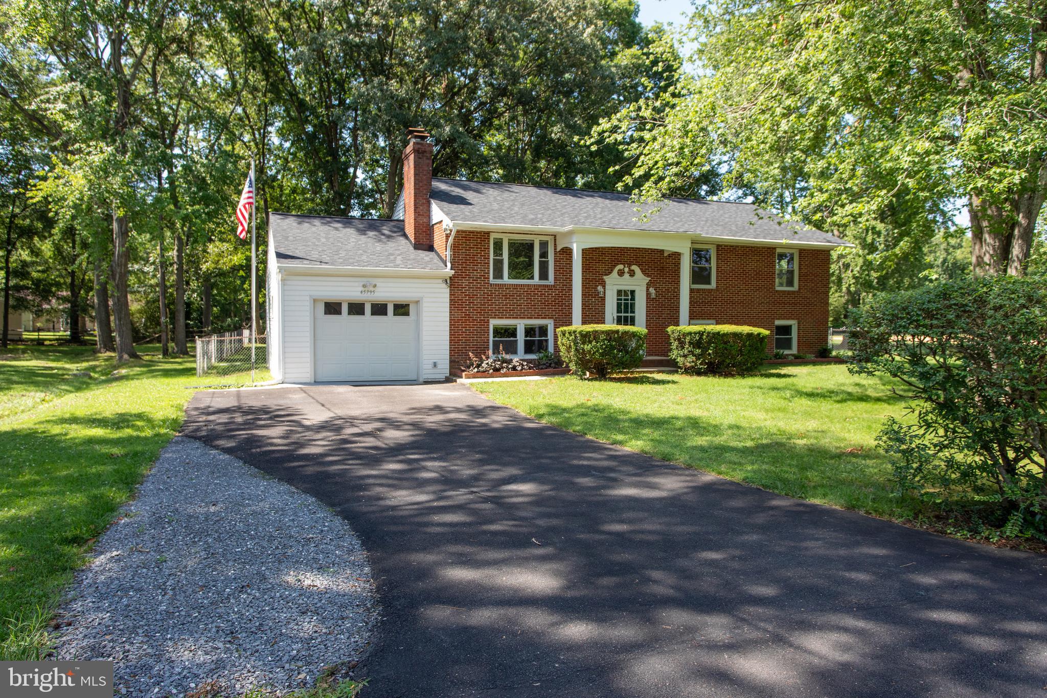 Move-in ready! Welcome to 45795 Filmore Drive in Great Mills—a solid all-brick split foyer tucked away in the Greenview neighborhood on a spacious 0.46-acre lot. Featuring 4 bedrooms plus a bonus room/flex space, 2.5 baths, fresh paint throughout, and all-new flooring, this well-maintained home offers an outstanding combination of space, updates, and flexibility for today's lifestyle.

The updated kitchen features ample cabinet space, stainless steel appliances—including a built-in microwave, dishwasher, and refrigerator with ice maker—and opens to a bright sunroom that provides additional living space to enjoy year-round. The main level also offers a comfortable living room with a cozy wood-burning fireplace, a separate dining room, and generously sized bedrooms.

The finished lower level features a large family room with built-in shelving, a second fireplace, additional living space, and a versatile bonus room that's ideal for a home office, gym, hobby room, guest room, or playroom, plus plenty of storage.

Step outside to a huge, level, fully fenced backyard that offers exceptional privacy and plenty of room for entertaining, pets, gardening, play, or simply relaxing outdoors. The expansive wood deck is perfect for summer cookouts, while the backyard shed provides additional storage for tools and lawn equipment.
Recent major updates include a new roof (2023), new water heater (2023), fresh interior paint throughout, and all-new flooring, giving buyers peace of mind and allowing them to move in with confidence. Sellers are also providing a one-year seller-paid home warranty for added peace of mind.

Conveniently located less than 10 minutes from Patuxent River Naval Air Station and close to shopping, dining, parks, schools, and recreation, this home offers the perfect combination of comfort, convenience, and value in a desirable Southern Maryland location.