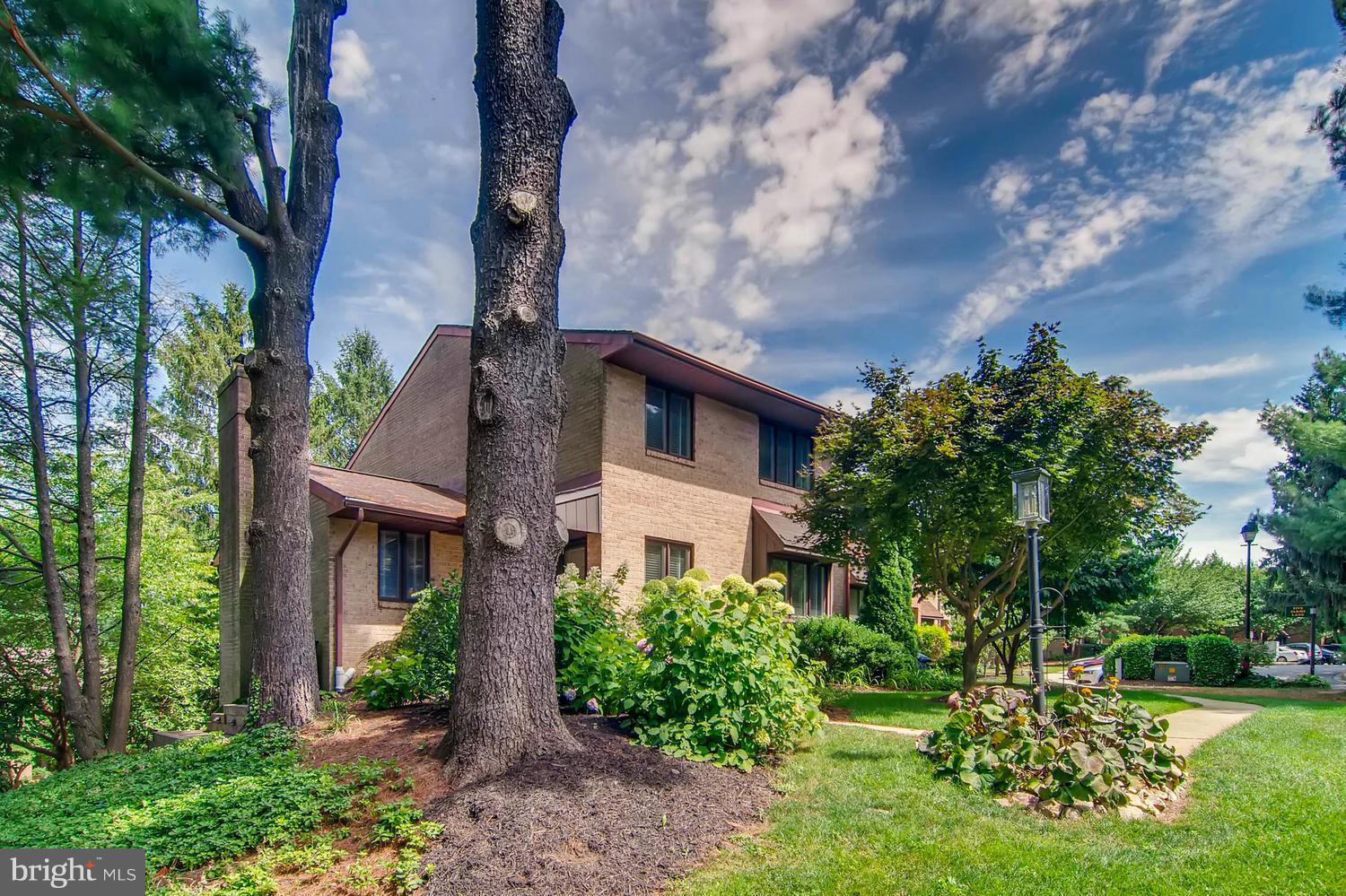 This rarely available end of group townhouse has 2 story bump out allowing for  main level family room w/FP & lower level bedroom. Renovated in 2015, this  home has hardwood throughout main level, stainless steel appliances, granite counters, & wet bar in dining room. Upper level boasts large bedrooms & two updated bathrooms. Lower level family room has sliders to patio, bedroom, and full bath.