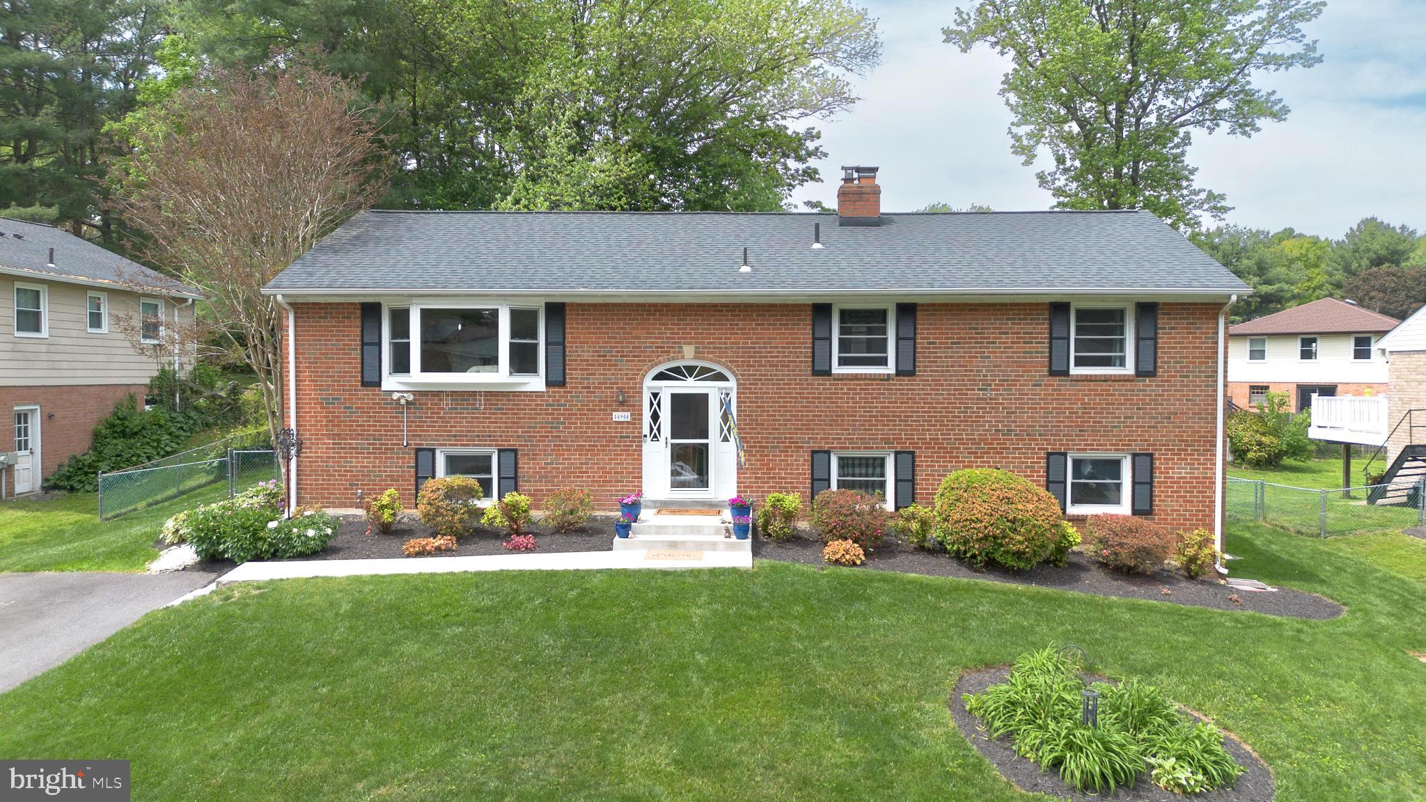 Welcome to this beautifully maintained and thoughtfully updated 5-bedroom, 3-bath brick split foyer colonial offering the perfect blend of space, comfort, and style! From the moment you arrive, you’ll appreciate the inviting curb appeal, expansive driveway, and private backyard retreat designed for both everyday living and entertaining. Step inside to discover a bright and open-concept main level featuring beautiful oak wood floors, abundant natural light, and a seamless flow between the living room, dining area, and renovated kitchen. The stunning kitchen overlooks the dining space and boasts stainless steel appliances, updated finishes, and ample cabinetry, creating the perfect gathering space for family and guests alike. The main level also includes an updated hall bath, an expansive primary suite with a private en-suite bath, and two additional spacious bedrooms. The fully finished walkout basement offers incredible versatility with a large living area centered around a charming wood-burning fireplace, a second kitchen, full bath, two additional bedrooms, and direct access to the backyard concrete patio and beautiful gazebo. Outside, enjoy a private backyard with tons of usable space perfect for relaxing, gardening, play, or summer gatherings. Recent improvements include: Water Heater (2017), Roof & Gutters (2018), Basement Carpet (2019), Windows (2020), Kitchen (2021), Kitchen Appliances (2022), Driveway Asphalt (2022), Front Walkway (2022), Gazebo (2022), Heating/AC System (2024), Washer/Dryer (2025), Primary Bath Shower Surround (2025), Microwave, Front/Side Doors, Bathroom Floors, & Ceiling Fans (2026), Refinished Kitchen Floors (2026), Upgraded Lighting (2026) & much more!