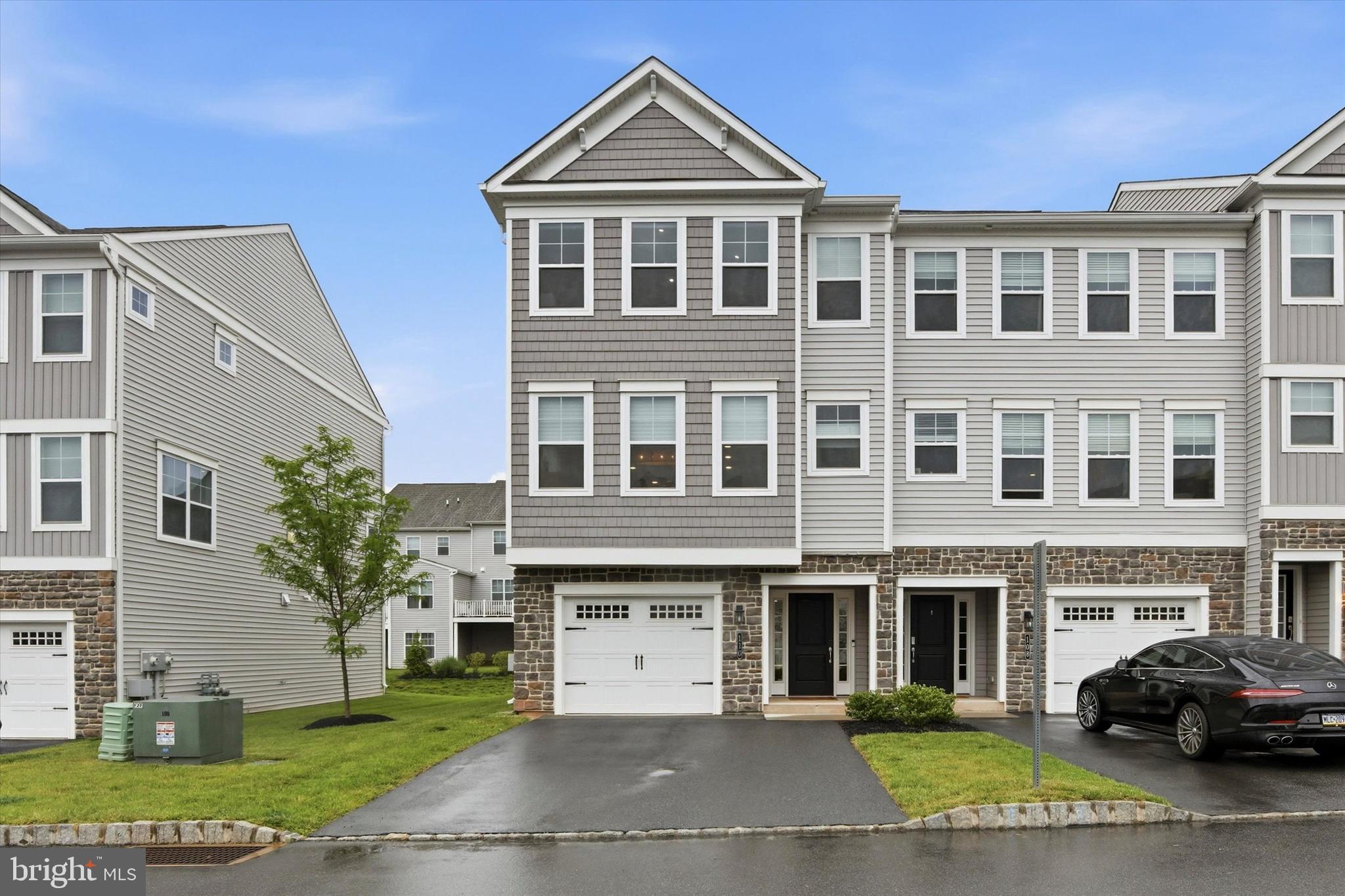 Welcome to 110 Harland Avenue, where modern luxury, thoughtful design, and low-maintenance living come together in the highly sought-after Everleigh at Limerick Pointe community. Built in 2022 and located within the award-winning Spring-Ford School District, this beautifully appointed home offers over 2,300 square feet of stylish, versatile living space designed for both everyday comfort and effortless entertaining.

Step inside to a welcoming first-floor vestibule entry featuring interior access to the attached garage, a spacious finished flex room ideal for a second living area, home office, gym, or playroom, and direct walk-out access to the rear patio. A large storage closet with custom shelving adds both convenience and functionality.

The second floor serves as the heart of the home, showcasing a bright, open-concept layout with soaring ceilings, oversized windows, and seamless flow between the living, dining, and kitchen spaces. The designer kitchen is beautifully appointed with an oversized island, upgraded cabinetry and lighting, stainless steel appliances, granite countertops, tile backsplash, and abundant storage - perfect for hosting gatherings or enjoying quiet mornings at home. Just off the main living area, a private deck offers the perfect space for outdoor dining or relaxing.

Upstairs on the third level, the spacious primary suite serves as a private retreat with a luxurious en-suite bath featuring a dual vanity, custom tile shower, and generous walk-in custom closet. Two additional bedrooms, a full hall bath, and convenient upper-level laundry complete this floor.

At the top level, a stunning bonus flex space with a built-in bar and wine fridge opens directly onto a private rooftop deck, creating the ultimate indoor-outdoor retreat for entertaining, relaxing, or enjoying sunset views.

Enjoy all the benefits of newer construction without the wait; plus the convenience of HOA-covered lawn care, snow removal, and common area maintenance. Perfectly located just minutes from shopping, dining, parks, walking trails, Philadelphia Premium Outlets, Costco, Wegmans, and major commuter routes, this home delivers the ideal balance of comfort, style, and accessibility.

Modern, move-in ready, and meticulously maintained - 110 Harland Avenue is the one you've been waiting for.