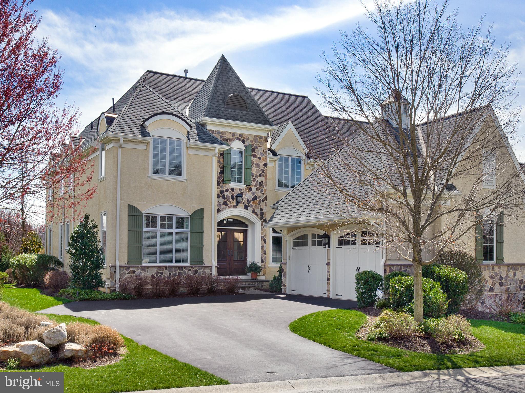 Award-winning Haverford Reserve affords a luxurious maintenance-free lifestyle in the heart of the Main Line. Here impeccably-crafted residences border a magnificent landscape of 124 acres of preserved woodland, with rolling hills, peaceful streams, walking and nature trails, and 45 acres of recreational areas to enjoy! This exquisite Pembrey model set on a premium private lot with scenic views is finely appointed and generously-sized for your family. Interiors are enriched by 9’ ceilings, oak wood floors, tasteful moldings & wainscoting, and upscale finishes throughout. Outdoor pleasure is had on the fabulous rear deck and enormous patio for summer barbecues, cocktail parties, or simply lounging with the paper while taking in the views. Kids and pets can play nearby on the lovely lawn area. This 4 bedroom, 4.1 bath beauty greets you with a gracious light-filled foyer with arched openings on both sides. At left is the elegant living room, and at right is the formal dining room providing a seamless flow for entertaining. A butlers pantry sits nearby with cherry cabinets, granite counters, and a wine fridge for easy serving. The chef will love creating meals in the spacious gourmet kitchen as the family gathers round the island or dines in the sunny breakfast room. Cooks quarters are appointed with floor-to-ceiling cabinetry, granite counters, and high-end stainless steel appliances. Open from there is the inviting vaulted family room with a soaring beamed ceiling, wood-burning fireplace, and built-in entertainment center for TV, movie and sports nights. Glass-paneled doors open to the deck and paver stone patio oasis for effortless indoor-outdoor living/hosting. An office with handsome cherry built-ins, mudroom with wall of windows, guest powder room, and 2-car garage access complete the main level. Upper level sleeping quarters present 3 well-proportioned bedroom suites. The expansive owners retreat offers his & her walk-in wardrobe closets, and a lavish primary bathroom with dual vanities, marble floors, soaking tub and oversized spa shower. An added bonus room with French glass doors is a perfect home office, sewing/crafts room, playroom, etc.; plus there is laundry and abundant closets on the 2nd level. The finished lower level has a comfortable family area, adjoining sitting/game room, bedroom and full bath. This wonderful home is also prepped for an elevator, has built-in speakers in the living room, kitchen and family room, and sits in a coveted location near the Main Lines best offerings.