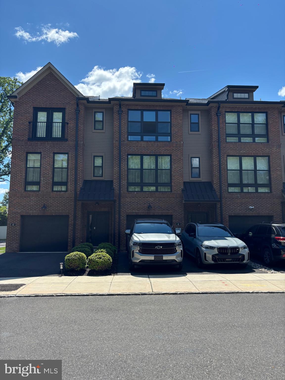 Fantastic modern townhome in the lovely Brickyard community conveniently located just minutes from Route 1 and PA Turnpike, 2 miles to Septa Trevose Station, shopping and restaurants within close proximity. This contemporary style townhouse features an open floor plan with 4 levels of living space: 3 bedrooms, 2 full bathrooms, 2 half bathrooms and a loft. The entry level foyer provides access to the 1 car garage with overhead storage space, a walk in closet, laundry, utility closet, powder room and a living space with walk out access to the backyard. Ascend to the second floor to the open floor plan with 9 foot ceilings and huge windows with lots of light. Here is where the kitchen, dining room and family room are, along with a sliding glass door that opens to the beautiful deck. The family and living rooms are accented with a stunning brick wall and a pantry with a sliding barn door in the kitchen. The gourmet kitchen offers a large island, stainless steel appliances, 42 " kitchen cabinets and upgraded countertops. The third level is where you will find the Master Suite with vaulted ceiling, master full bathroom, large closets and 2 nice size bedrooms along with a full hall bathroom that completes the 3rd floor. The 4th level is a bonus room which has a wet bar and leads out to the fabulous rooftop deck.