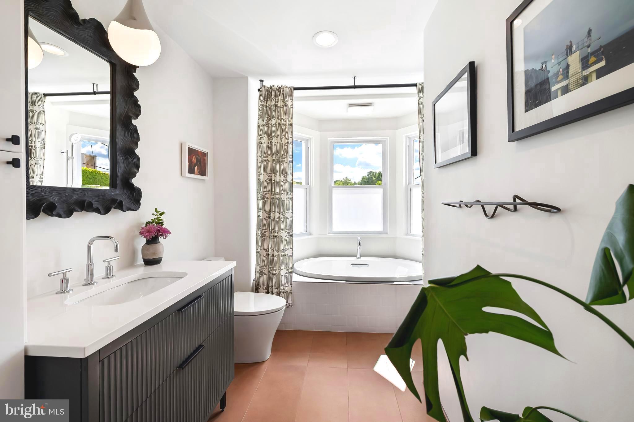 Set on a tree-lined street just one block from Wyman Park, this 1901 rowhouse marries design magazine–worthy style with Hampden soul. From 2019 to 2024, the home’s devoted stewards took on a slow and intentional renovation—living in the space, mapping how natural light moved through each room, and letting the architecture guide their choices. With their own hands and a deep respect for the home’s history, they elevated every inch while honoring its original bones.  Thoughtfully reimagined to meet modern-day needs, they made the most of the home’s footprint—creating a space that feels tailored, timeless, and rarity in today’s market.

Beyond the classic Baltimore porch—complete with a little front-yard Free Little Library crafted from a reclaimed newspaper stand—the main level flows from an electric fireplace–anchored living room to a dining room. A sleek galley kitchen features honed, easy-to-maintain soapstone counters, a large sink, smart storage, and open shelving. A powder room and laundry closet are tucked neatly out of sight for everyday ease.

Upstairs, a light-filled bedroom sits across the hall from a separate built-in workstation room—ideal as a remote office or cozy reading nook. The showstopper: a bathroom designed by local designer Kelsey McNerney of By Noone Studio, with a spa-like tub perfectly positioned under three windows to capture natural light. The top floor adds another bright bedroom and a versatile bonus room currently used as a walk-in closet but easily transformed into a third bedroom or work space. Connected to the third room is a second full bath, anchored by a stunning marble sink, generous storage, and a large, loft-style shower.

Fresh white paint, modern light fixtures, and lightly rebrushed original floors layer texture and brightness throughout, while an unfinished basement awaits your storage needs.

Step outside to a generous deck that flows onto a stone patio—perfect for al fresco dinners under café lights—while a multi-purpose shed keeps bikes, tools, and gear tucked away. A private parking pad takes the hassle out of city parking. Here you will be close to nearby restaurants, boutiques, parks, and the vibrant energy of “The Ave,” and just down the road from  I‑83. This home is a rare blend of heart, style, and location—ready for its next chapter with a new steward. OFFER DEADLINE - TUESDAY, MAY 13th at 10AM.