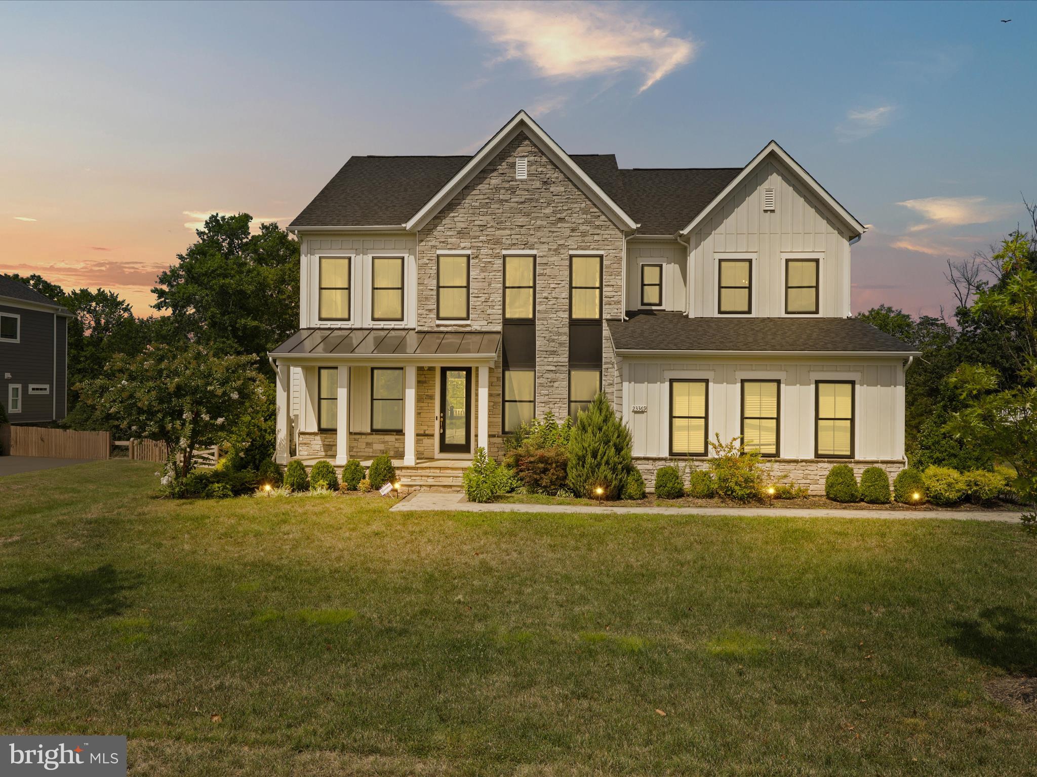 Welcome to the most desirable community in Northern Virginia – welcome to Hartland. Step inside to the sophisticated DRB Emory II Model Home. Over $350,000+ Worth of Upgrades included. This a modern farmhouse situated on half-acre (1/2) “North East Facing”. This stunning home embodies luxury, comfort, and elegance, offering an exceptional living experience for the discerning homeowner. With its impeccable design, craftsmanship, and unparalleled amenities. Situated on a meticulously landscaped lot Backing to woods, This home boasts exquisite curb appeal and an inviting presence. Step inside, and you'll immediately be captivated by the grandeur of the foyer, featuring soaring ceilings and an abundance of natural light. 3 finished levels, custom model features such as reclaimed wood beams on ceiling, feature walls, and loads of upgrades. with almost 5400 finished square feet on two levels, 6 bed rooms and 4.5 baths 2-CAR GARAGE. The large brick-front porch invites you into a beautifully designed open-concept floor plan, complete with upgraded luxury vinyl plank flooring and exceptional finishes throughout. The main level features a spacious library with custom built-in shelving, a separate dining room, and a large gourmet kitchen, perfect for cooking and entertaining. The kitchen is equipped with an expansive center island, quartz countertops, stainless steel appliances, walk-in pantry and an adjacent breakfast area that overlooks the generously sized family room. Enjoy easy access from the kitchen/family room to the stunning covered porch,ideal for outdoor entertaining or relaxing with your morning or afternoon tea. A highlight of this home is the in-law suite on the main level of the Kitchen. Upstairs, you'll find 4 spacious bedrooms, 3 full bathrooms, and a separate laundry room for convenience. The large primary suite features a Vaulted ceilings w/ beams, dual walk-in closets, a luxurious en-suite bathroom with dual vanities, and a separate two-headed seamless glass shower. The 3 secondary bedrooms are all outfitted with upgraded carpet & 2 additional full baths, and an upstairs laundry room to complete the upper level. The fully finished walkout basement is a remarkable extension of the home’s living space, designed for both recreation and relaxation. A large rec room provides endless possibilities for entertainment, while a sleek wet bar with a quartz countertop makes hosting effortless. The dedicated media room is perfect for movie nights, and the gym room, allows for convenient at-home workouts. Additionally, the lower level includes a full bedroom w/ a walk-in closet and an attached full bath, making it an ideal guest or au pair suite. An unfinished area provides ample storage. Step outside onto a custom stone patio with expansive backyard and enjoy the serenity of your private backyard oasis. From quiet evenings under the stars to lively summer barbecues, this outdoor space is perfect for making lasting memories with family and friends. Beyond the stunning interiors, this home is further enhanced with an sprinkler system, ensuring lush landscaping year-round. Additional upgrades include a water softener, Tankless water heater and furnace humidifier, Fully integrated Security and Monitoring System ,In-Wall Speaker System and Premium Structured wiring, this estate offers an unbeatable location Walking distance to Old Farm Winery and Hartland Club House.*Premiere Loudoun county schooling*Residents enjoy proximity to picturesque wineries, the expansive Hal and Berni Hanson Regional Park, top-rated schools, premier shopping and dining destinations, and major commuting routes, including Route 50, Loudoun County Parkway, and Old Ox Road. This home is truly a rare gem, offering the perfect balance of privacy, modern luxury and unparalleled convenience.