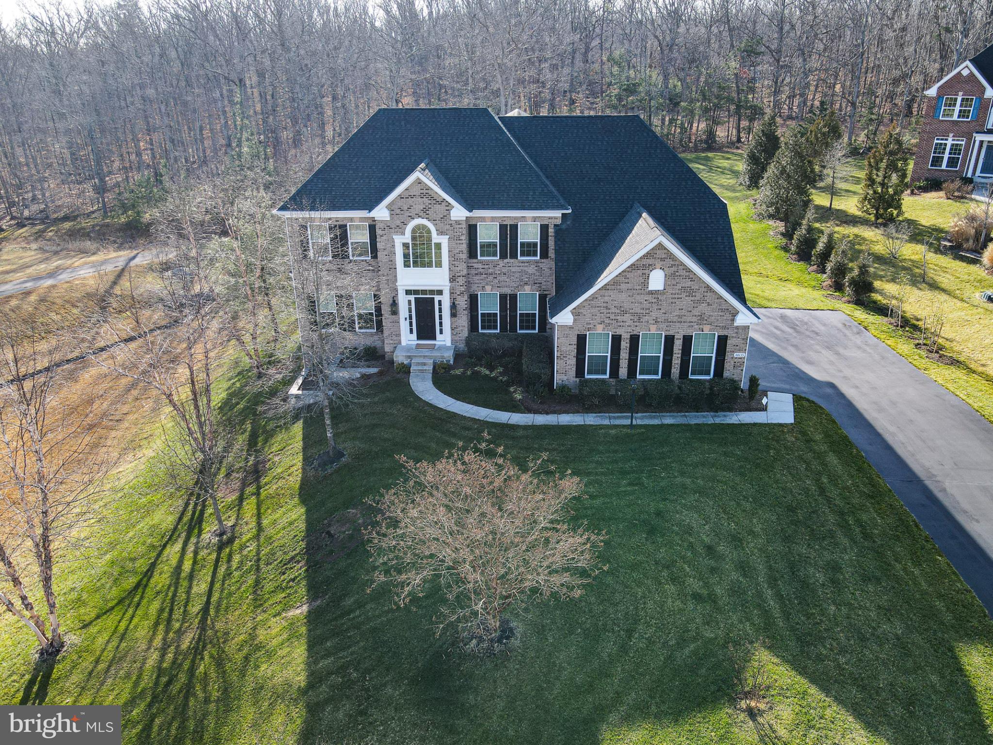 Welcome to an extraordinary estate in the prestigious enclave of Hampton Reserve in Fairfax Station—widely regarded as one of Northern Virginia’s most desirable zip codes. Perfectly positioned on a premium .98-acre lot with professional landscaping and custom hardscaping, this stunning Highgrove Model by Ryan Homes offers more than 7,000 square feet with exquisitely finished living space across three expansive levels.

A stately façade and 3-car sideload garage create a spectacular first impression. Inside, rich hardwood flooring flows throughout the main and upper levels, complemented by elegant formal living and dining rooms, a handsome private study, and a dramatic two-story great room with a graceful fireplace. The sun-drenched sunroom opens seamlessly to a Trex deck overlooking serene, pastoral grounds—an idyllic setting for both intimate evenings and grand-scale entertaining.

The gourmet kitchen is a masterpiece of design and function, featuring top-of-the-line appliances, an expansive center island, new gas cooktop and French door refrigerator (2023), extraordinary cabinetry, subway tile stone backsplash, spacious pantry, butler’s pantry, and a welcoming light-filled breakfast room.

Upstairs, the luxurious owner’s retreat offers a private sitting room and spa-inspired bath with dual vanities, soaking tub, separate shower, and private water closet—creating a true sanctuary. Three additional secondary bedrooms provide exceptional comfort and flexibility, including a thoughtfully designed Jack-and-Jill bath and a private en-suite—perfect for family members or guests seeking space, privacy, and convenience.

The fully finished walk-out lower level extends the home’s impressive footprint with a fifth bedroom, full bath, expansive recreation room, a dedicated theater room with built-in sound system—ideal for movie nights and game-day celebrations, and a second fireplace. An oversized storage room ensures ample space for organization. Outdoors, the elegant paver patio with brick knee wall offers the perfect backdrop for entertaining while enjoying the tranquil, private setting.

Extensive upgrades and smart-home enhancements include:
• New HVAC system with ultraviolet light and humidifier (October 2023)
• Sonos whole-home speaker system
• Ring doorbell
• Automatic and timed lighting throughout
• Hunter Hydrawise 10-zone irrigation system
• Insulated garage doors
• Electric Vehicle Outlet installed in garage

Ideally located near dining, shopping, and recreation, with convenient access to I-495 and VRE for seamless commuting, this exceptional residence delivers luxury, sophistication, and an unparalleled lifestyle in one remarkable offering.