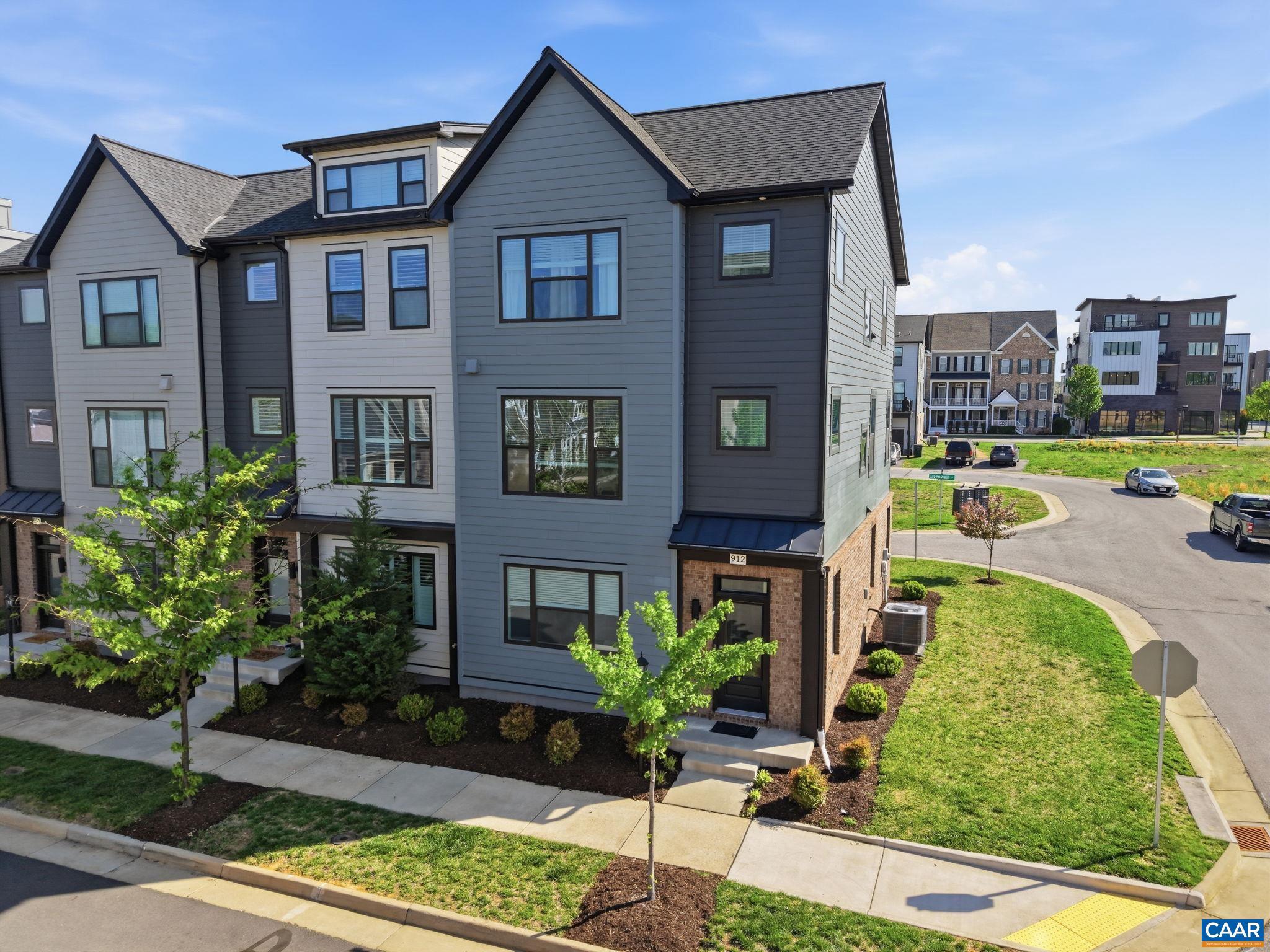 This low-maintenance, one-owner Bainbridge model by Southern Development Homes features four bedrooms, four baths, and all of the views. Countless customizations mean this gem is brimming with upgrades, from elevated lighting and plumbing fixtures to top-of-the line maple cabinetry and Adura Max flooring throughout. Enjoy entertaining in an expansive, open-concept design seemlessly connecting the living room, dining area, and a half-bath to the gourmet kitchen with an oversized 9-foot granite island, stainless steel appliances, and built-in pantry cabinetry. Directly off the main living space is an 8�20-foot Trex deck featuring scenic mountain views. Upstairs find three bedrooms, two full baths, and convenient laundry utilities. The primary bathroom boasts cultured marble counters, ceramic tile flooring, custom framed mirrors, and a tiled shower with a double niche and a frameless door. The fourth bedroom with full bathroom on entry level makes an ideal setup for private home office, guest suite, or work-out room. Pearl Certified, HERS Rated, and built to rigorous energy-saving benchmarks. Perfectly situated at the foot of the beautiful Blue Ridge Mountains within easy walking distance restaurants, coffee, gym, pool, and shops.